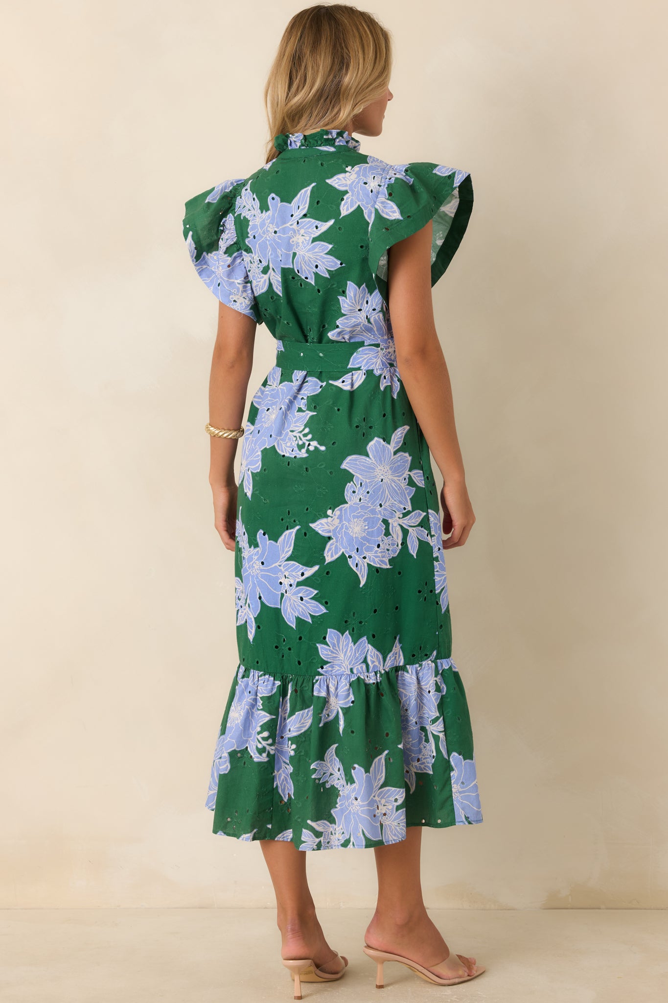 Rear view of the hunter green floral midi dress featuring a removable belt, flutter sleeves, lined fabric, and ruffle hem.