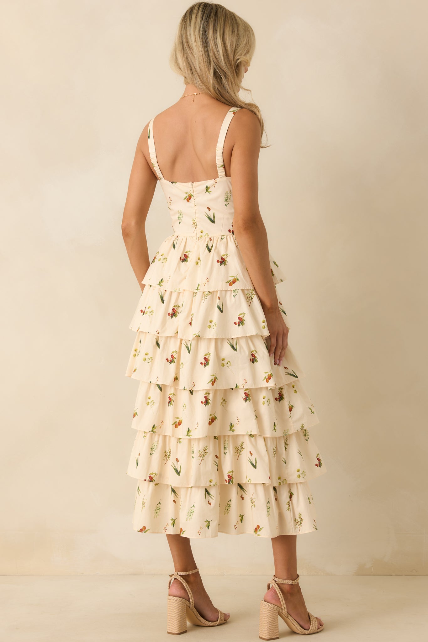 Rear view of the ivory midi dress highlighting hidden back zipper closure and tiered skirt flow.