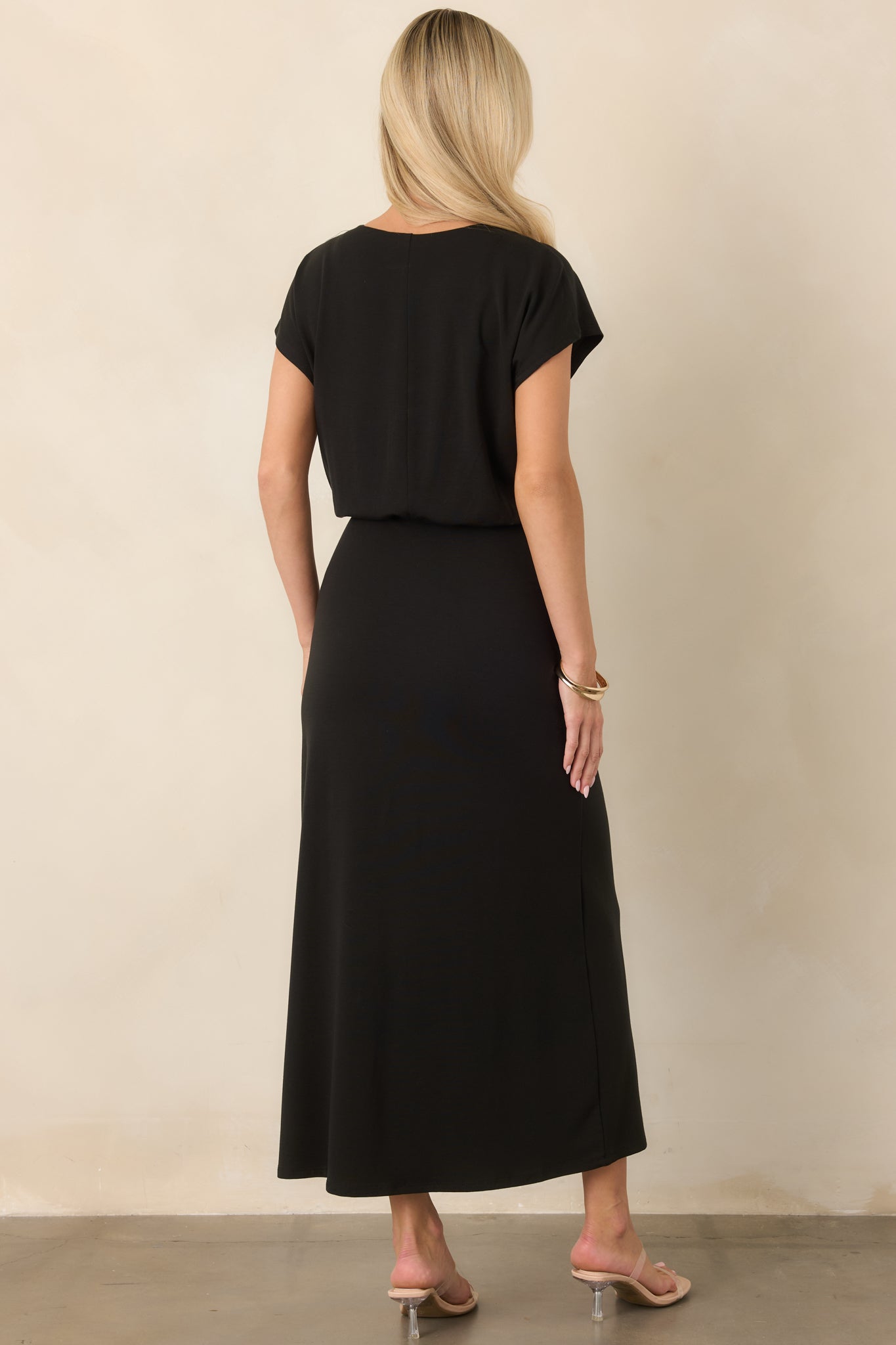 Rear view of the luxe stretch jersey midi dress highlighting the fluid blouson bodice, gently gathered waist, and streamlined skirt.