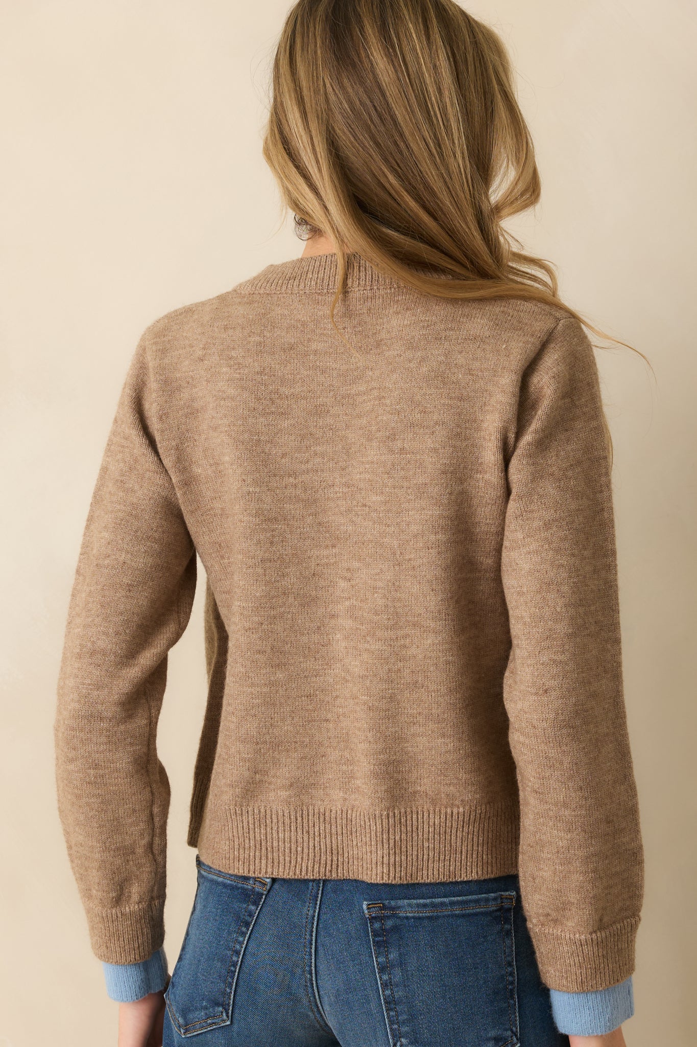 Rear view of the light mocha cardigan showing a clean, relaxed fit with long sleeves and subtle layered trim