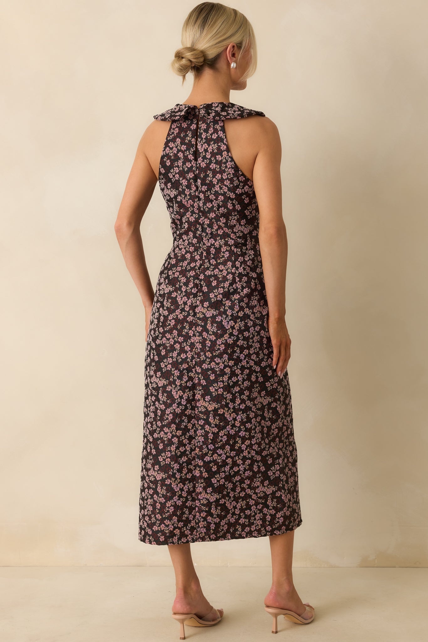 Rear view of the midi dress showing back keyhole button and hidden zipper closure.