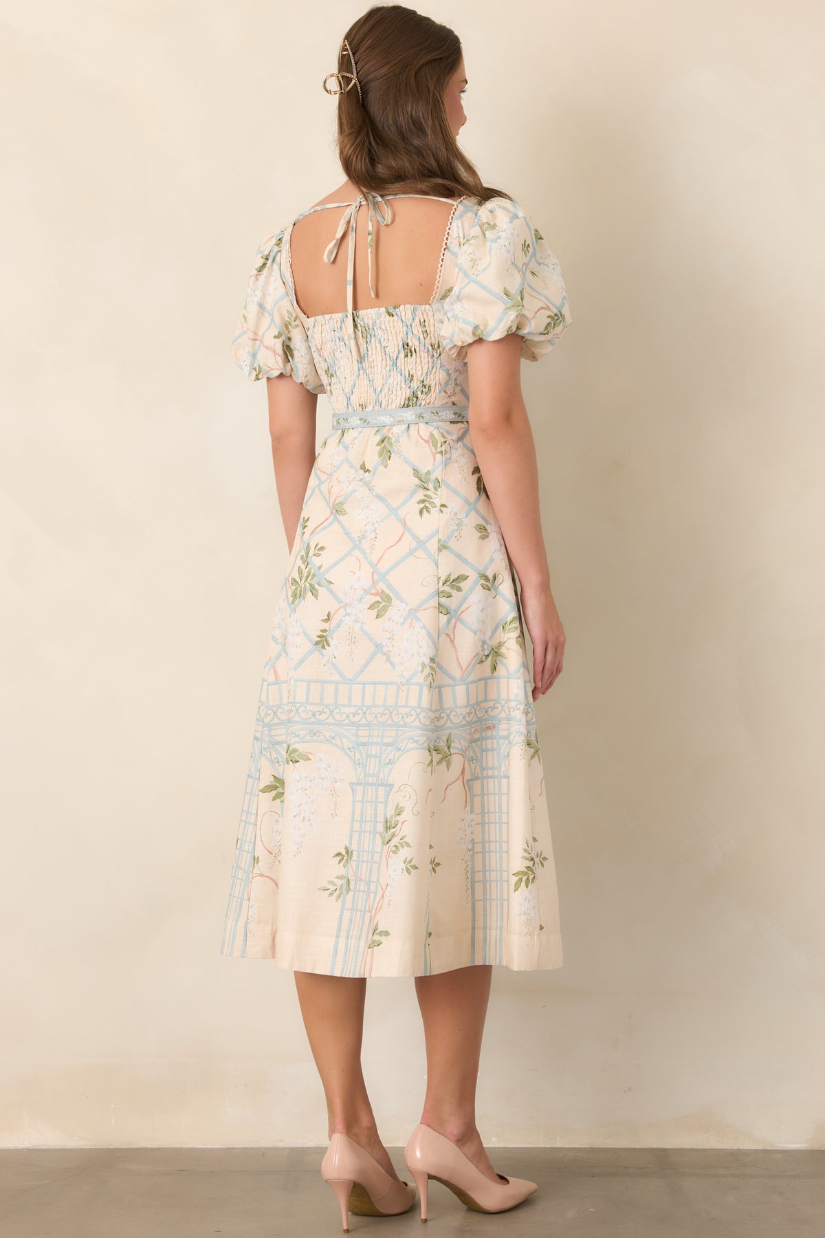 Rear view of midi dress with puff sleeves and coordinating waist belt