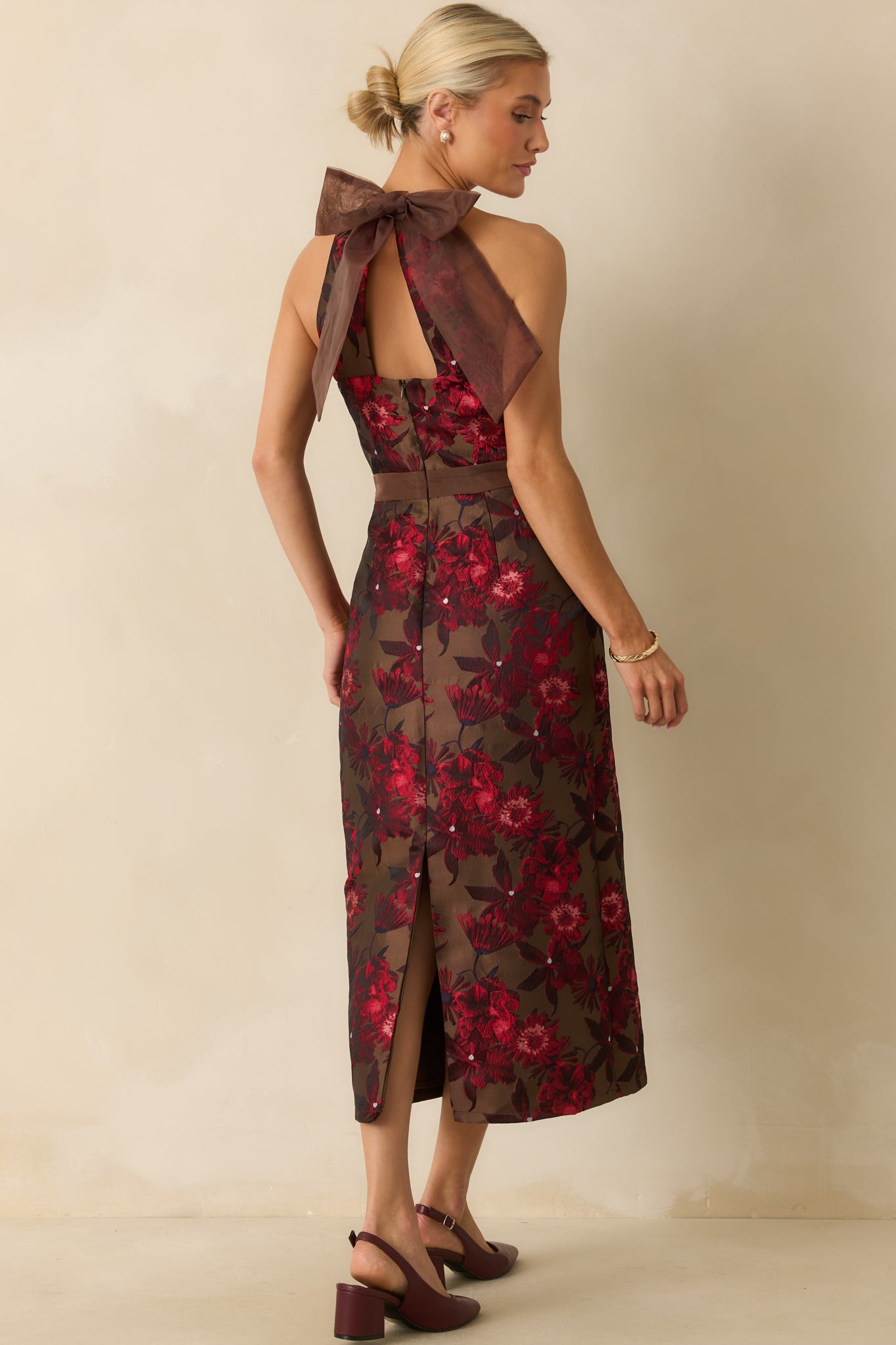 Rear view of the mocha jacquard midi dress highlighting the adjustable back bow tie, concealed zipper, and back slit hem.