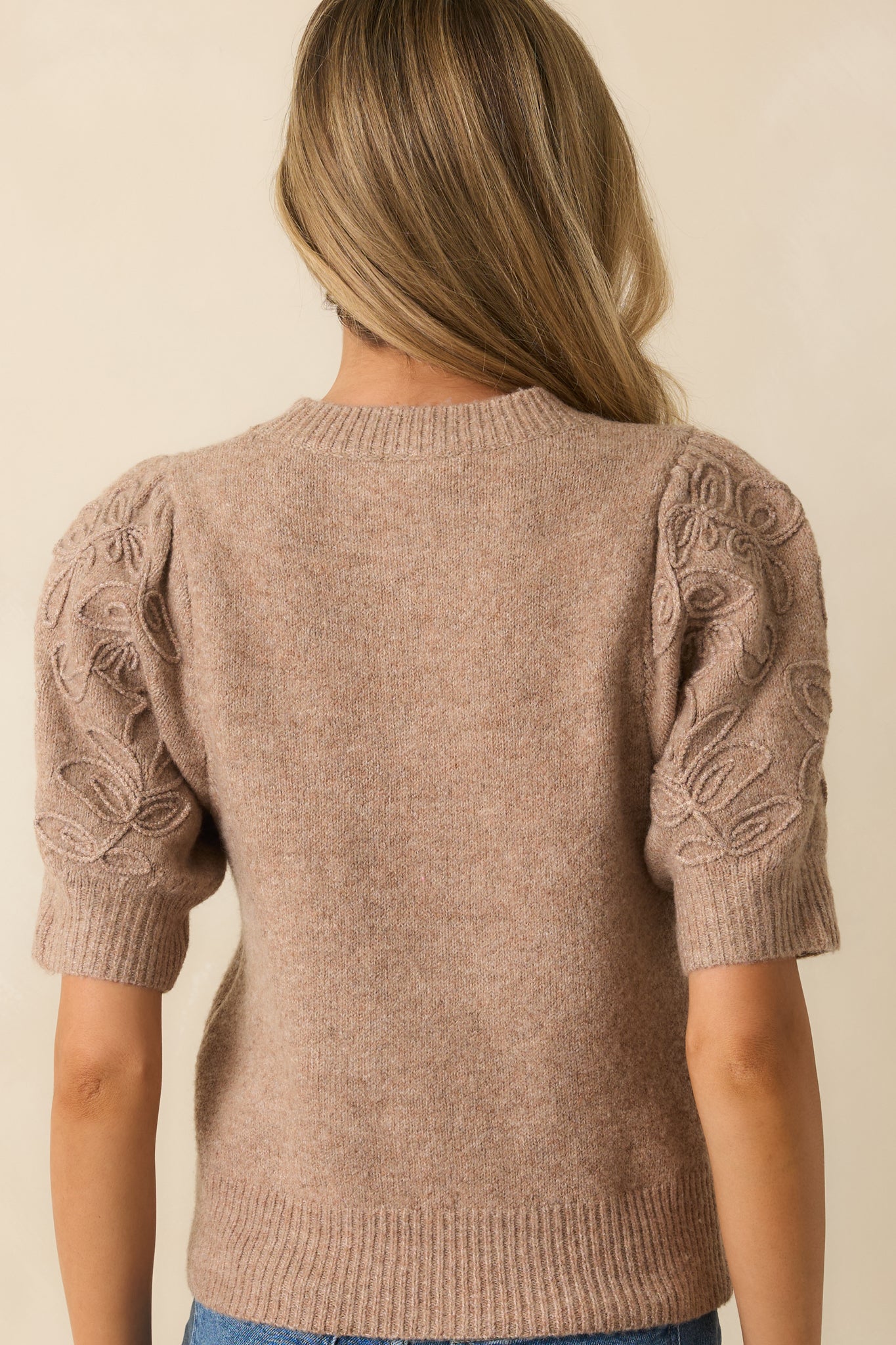 Rear view of the mocha knit sweater showing the smooth knit back and ribbed hem for a polished silhouette.
