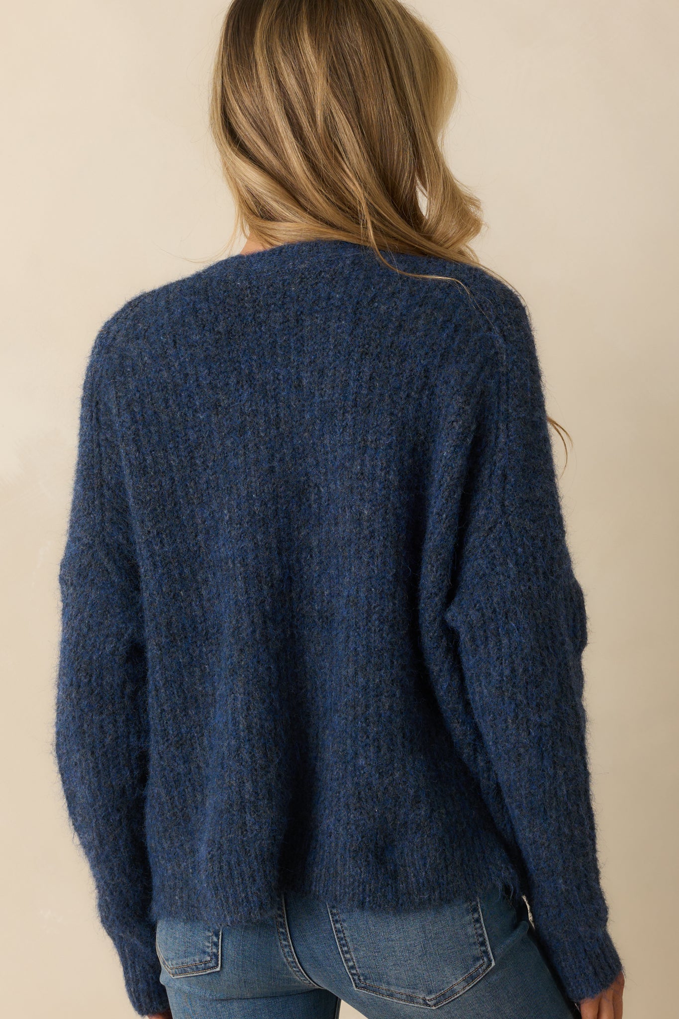 Rear view of the navy cardigan showing the relaxed fit and smooth ribbed knit finish.