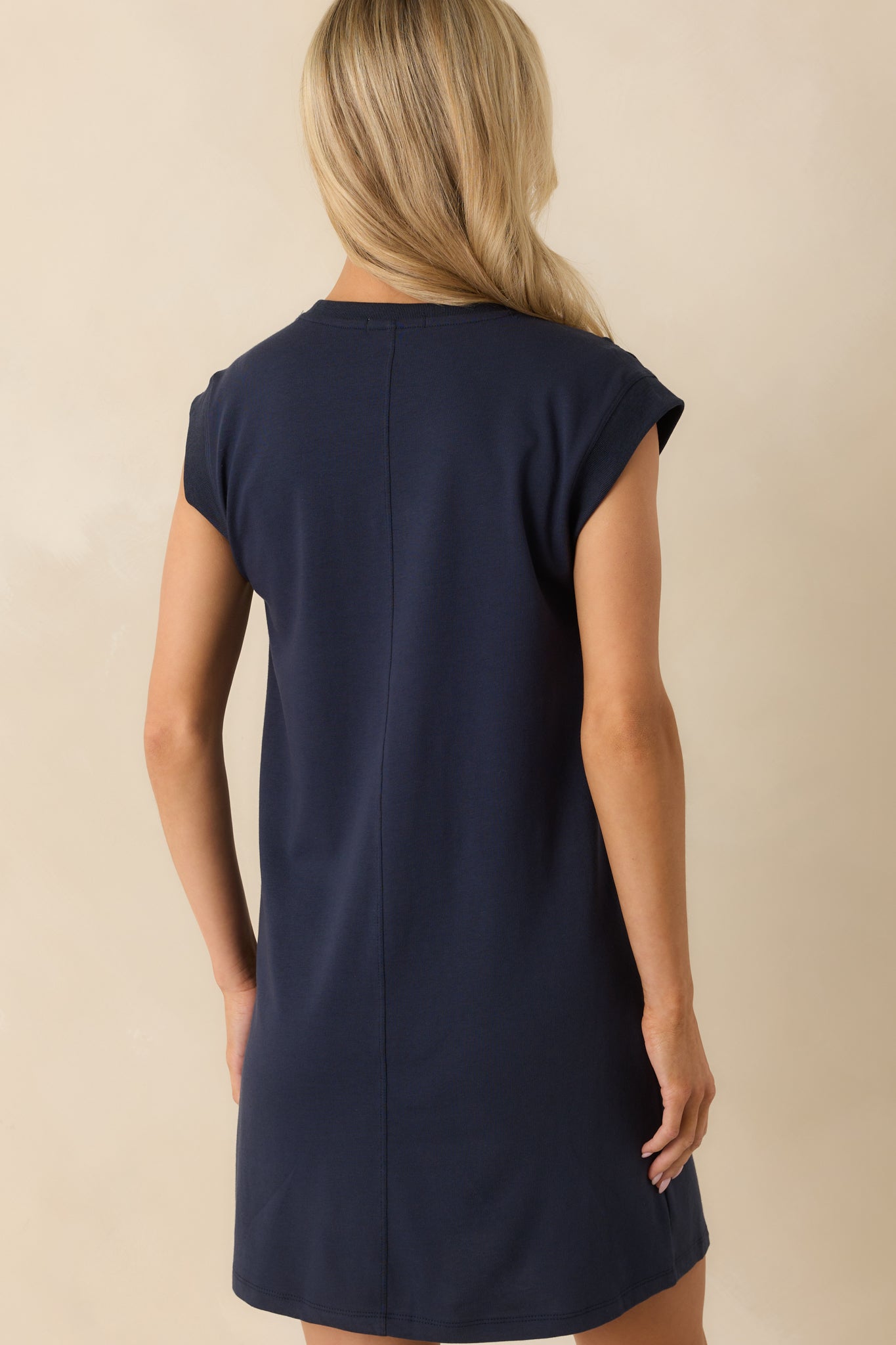 Rear view of the navy shift mini dress with a center seam detail.