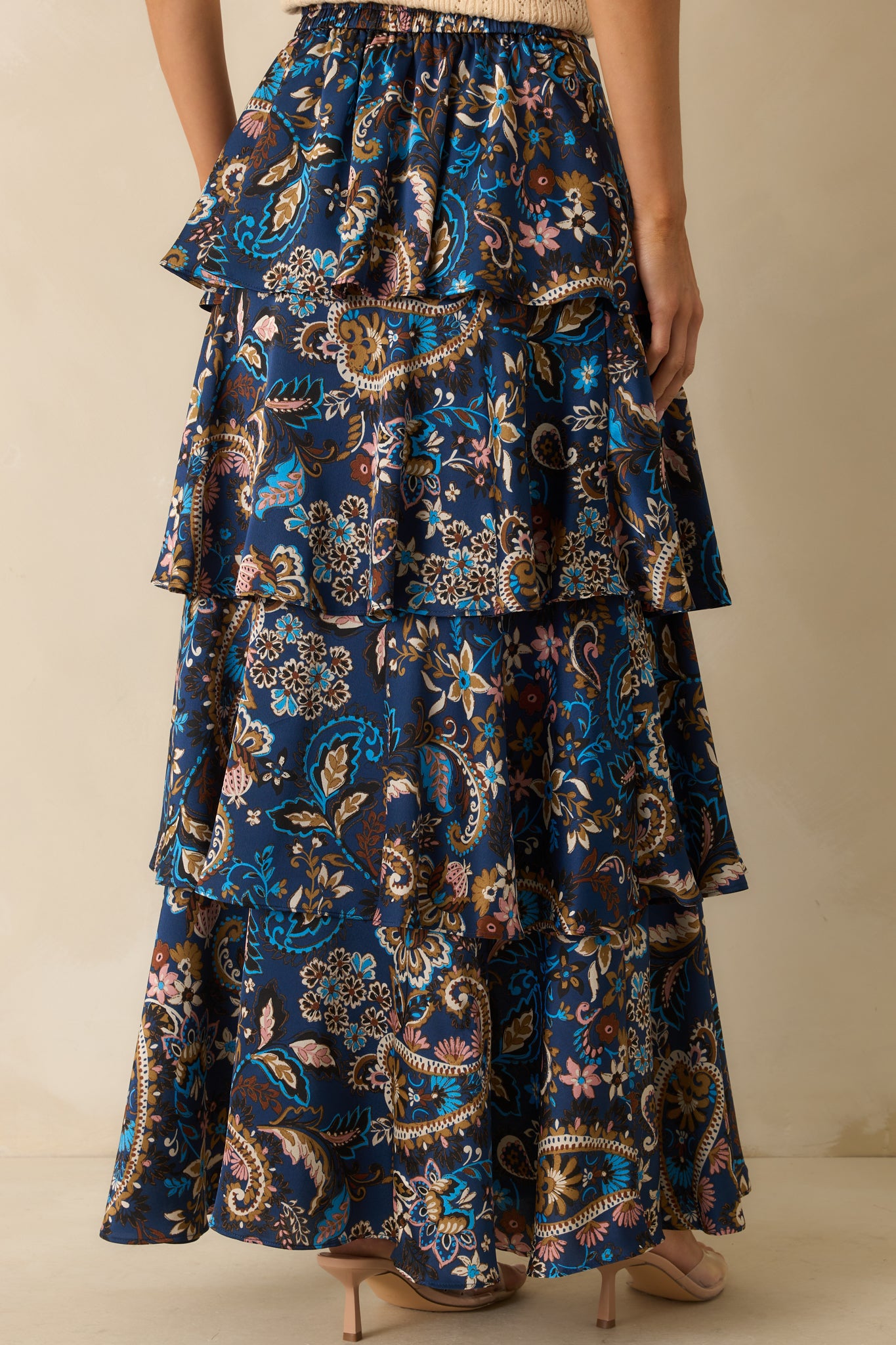 Rear view of the navy skirt showing the elastic waist insert and tiered satin layers.