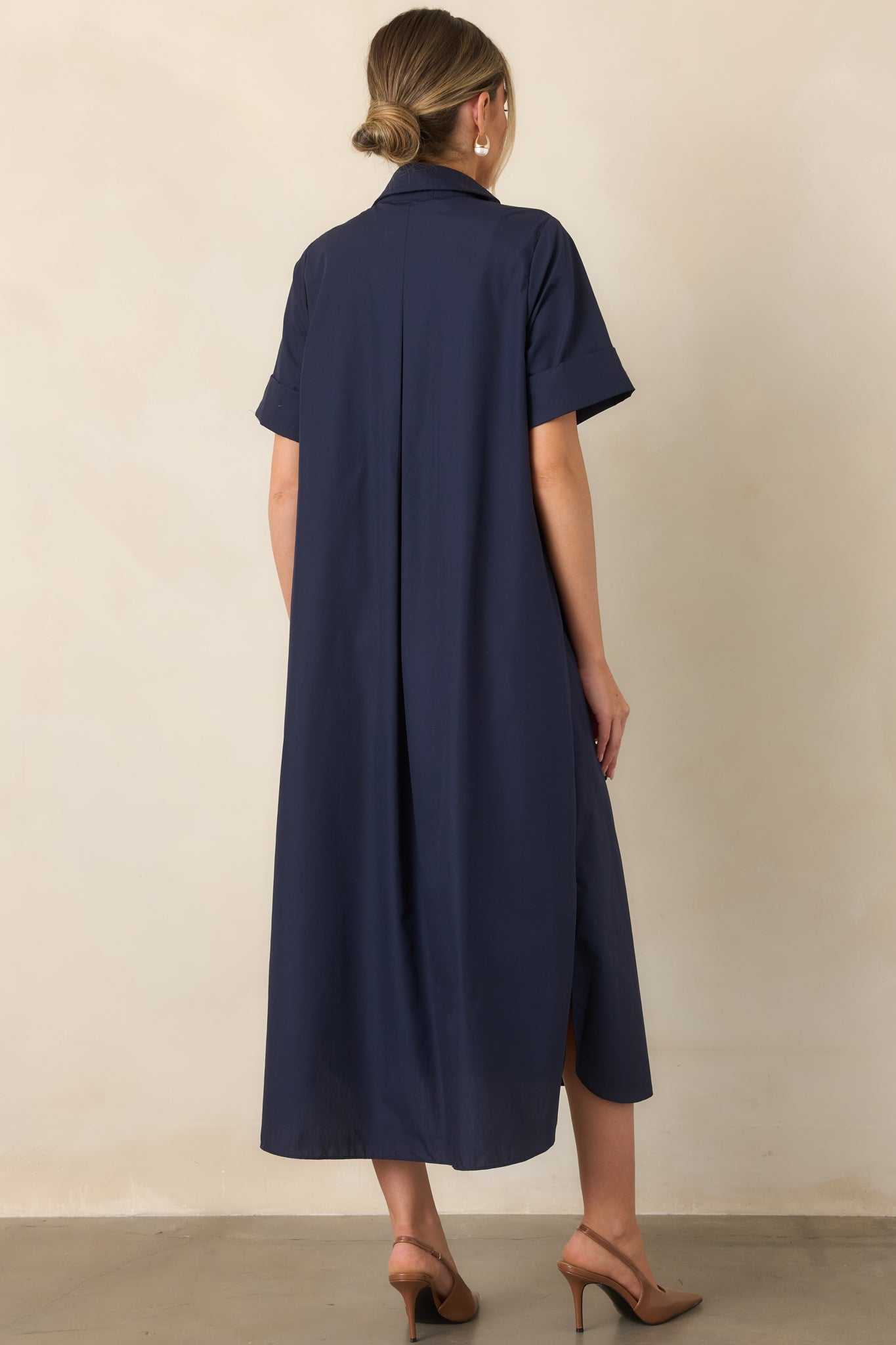 Rear view of the navy woven maxi dress showcasing its relaxed A-line silhouette and softly flowing design.