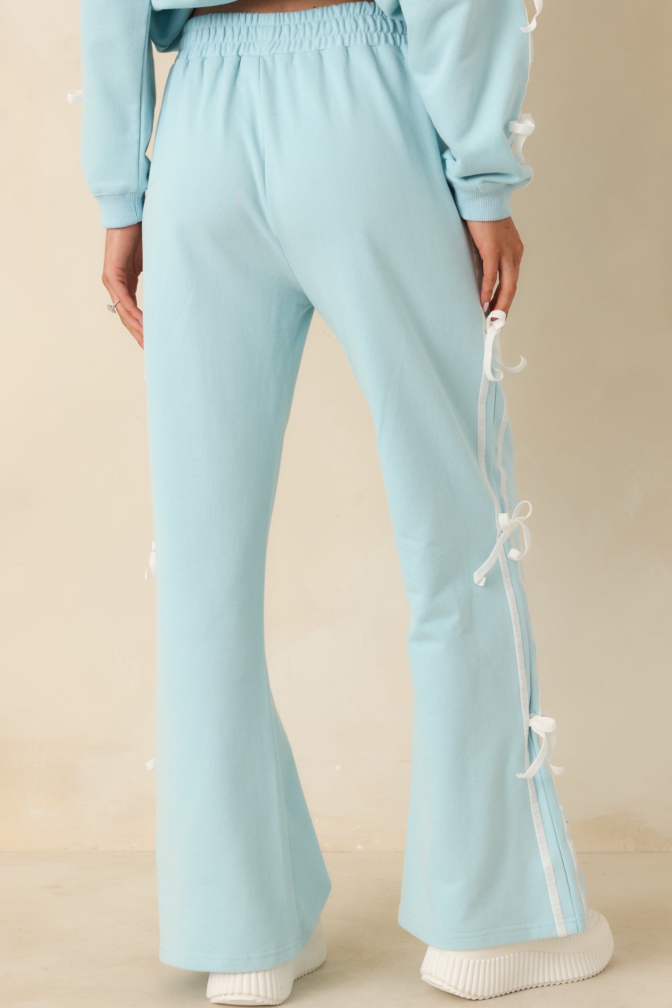 Rear view of aqua blue sweatpants showing straight-leg fit and relaxed silhouette.