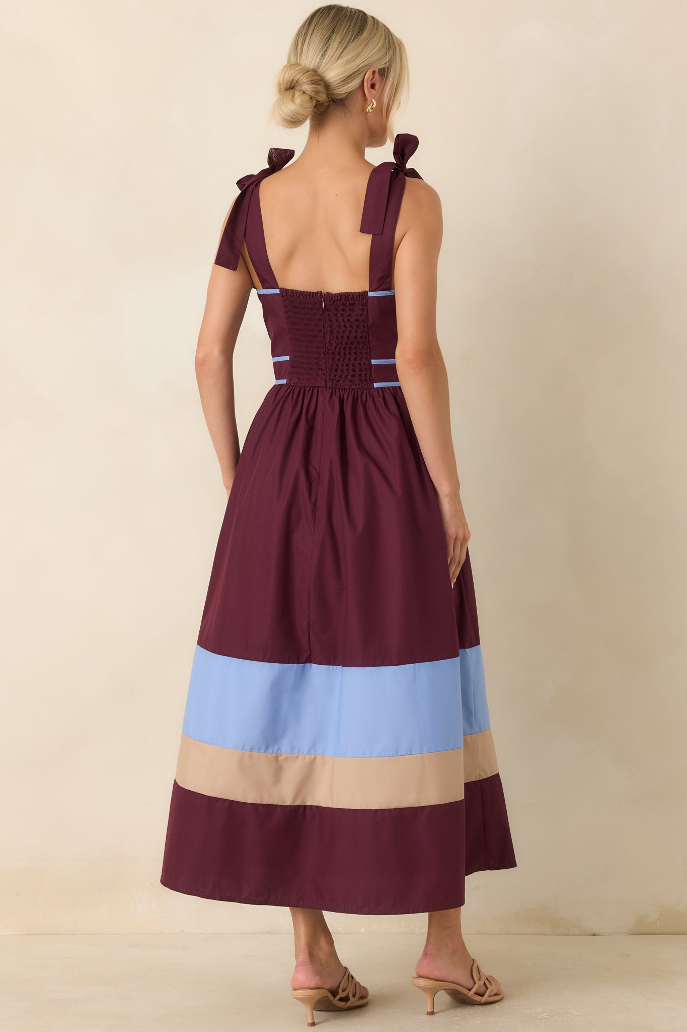 Rear view of the berry contrast midi dress showcasing the smocked back, self-tie straps, and flowing gathered skirt.