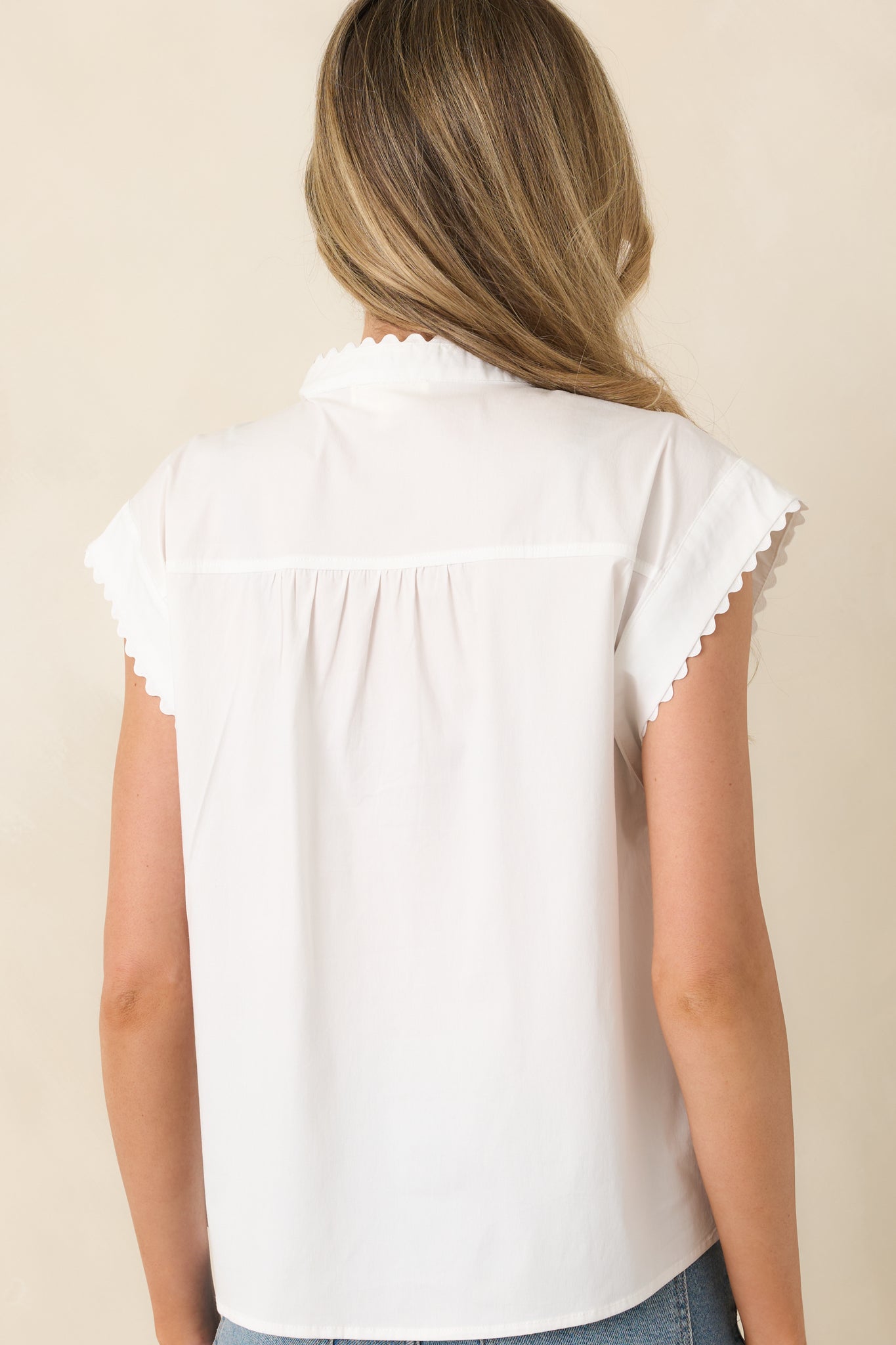 Rear view of cotton-blend blouse showing relaxed fit and smooth back silhouette.