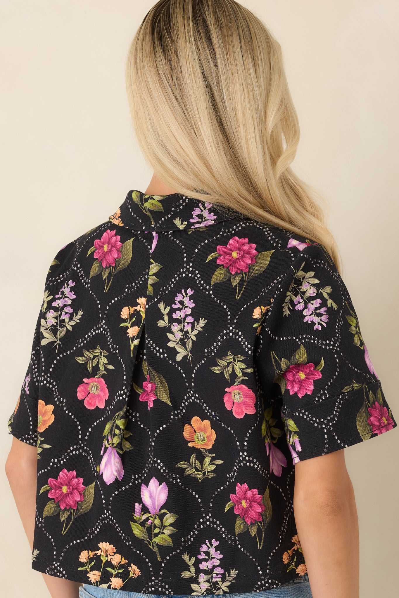 Rear view of the cropped top showcasing the colorful floral pattern and structured cotton-blend fabric.
