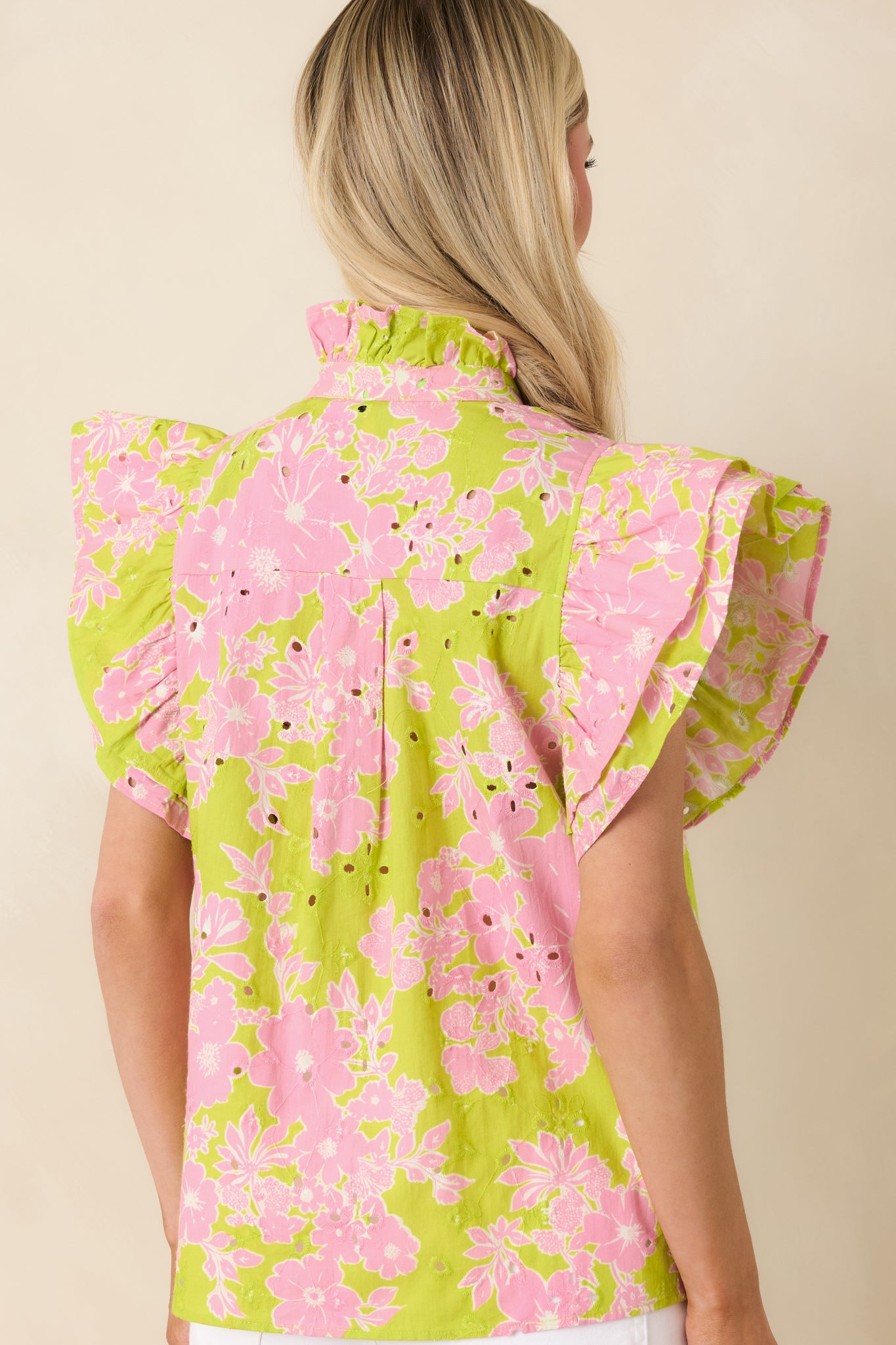 Rear view of floral eyelet top with relaxed fit and lightweight cotton fabric.