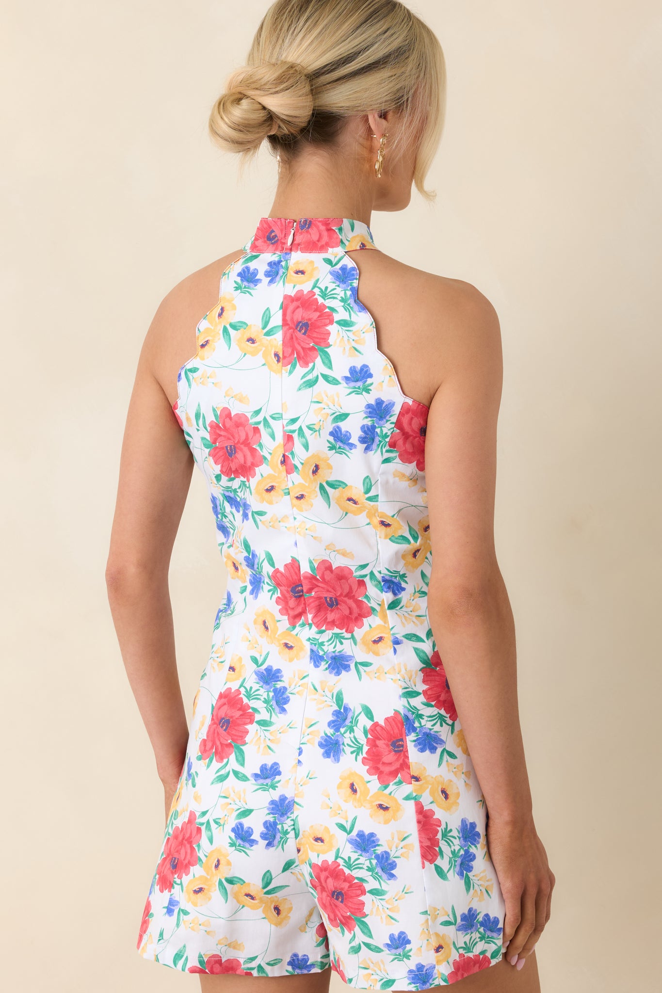 Rear view of floral halter romper with relaxed shape.