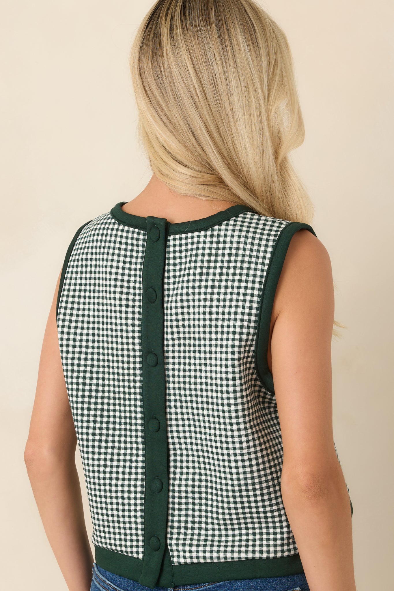 Rear view of the gingham top showcasing the button closure and clean cropped silhouette.