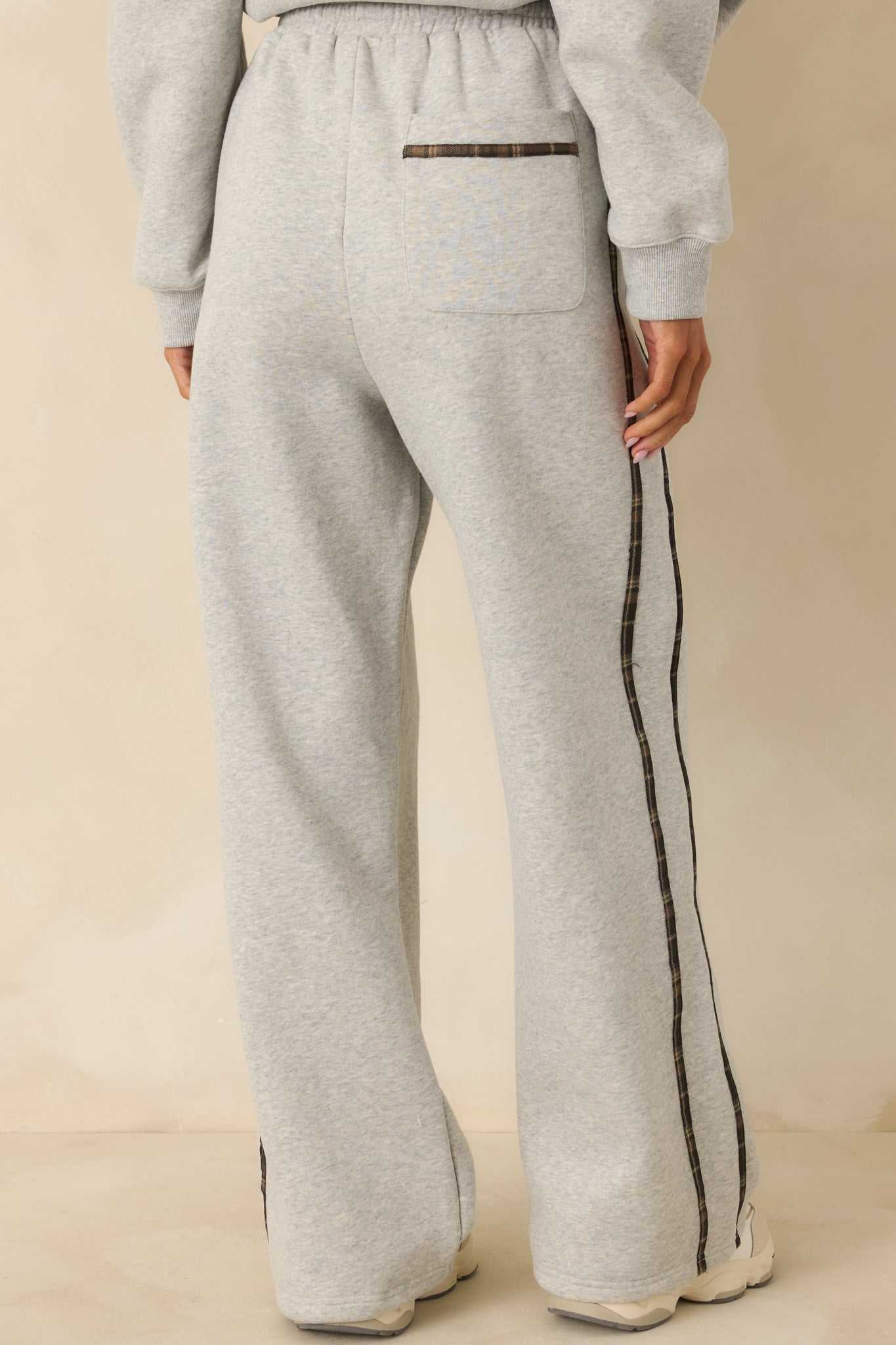 Rear view of heather grey sweatpants showing relaxed fit and straight-leg silhouette.