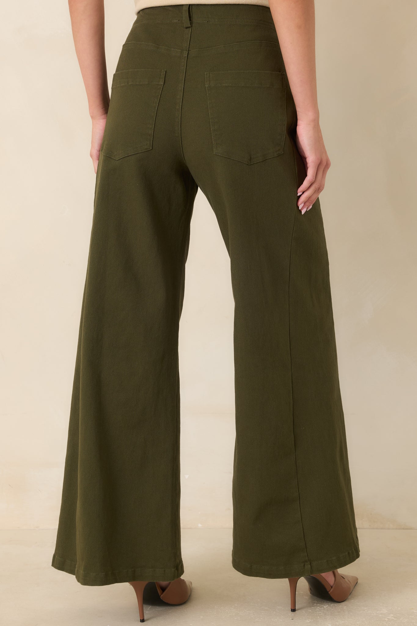 Rear view of the high-rise pants highlighting the angled back pockets and clean, tailored finish.