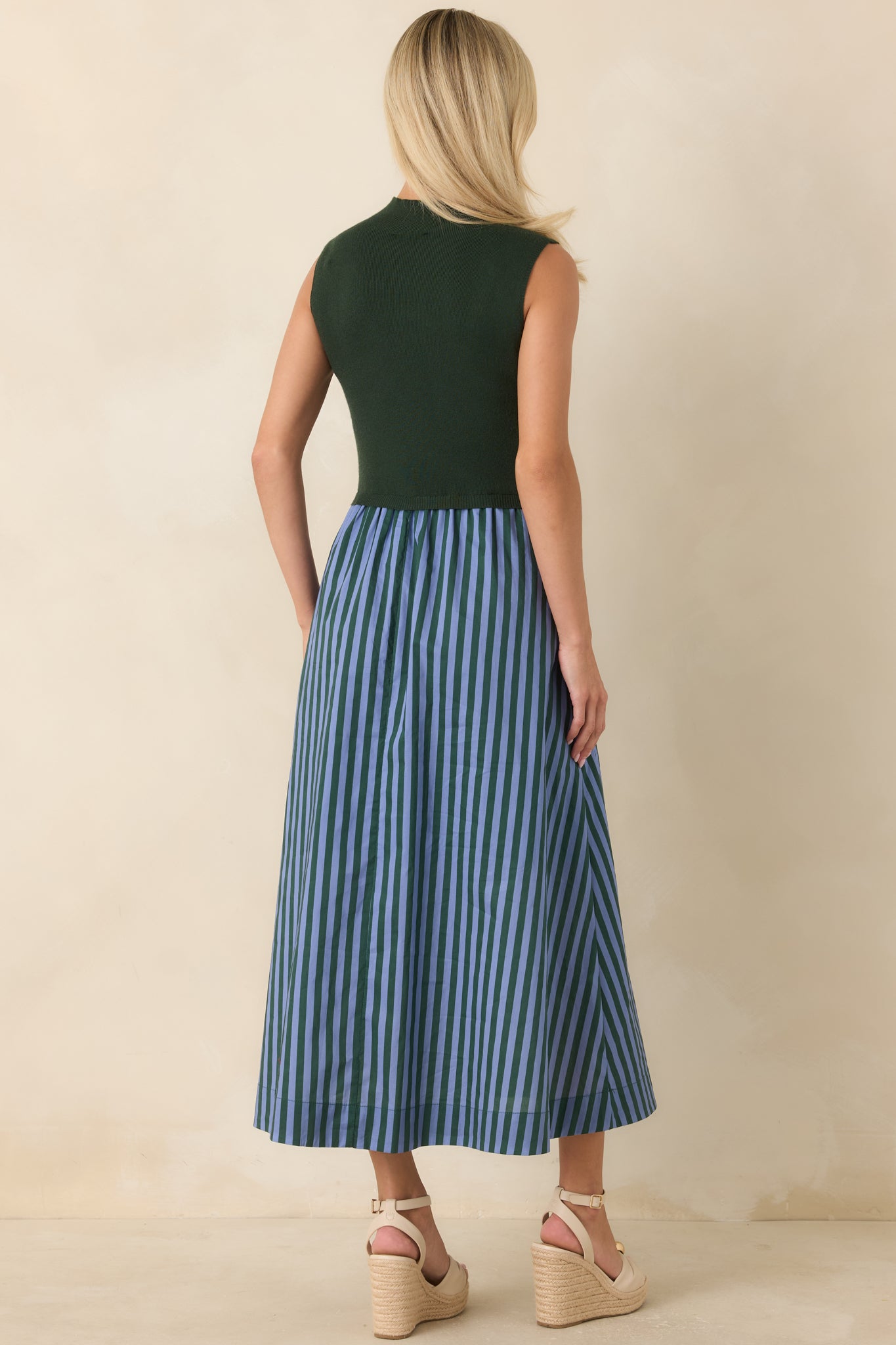 Rear view of the hunter green midi dress showcasing the sleeveless design and flowing A-line skirt with striped accents.