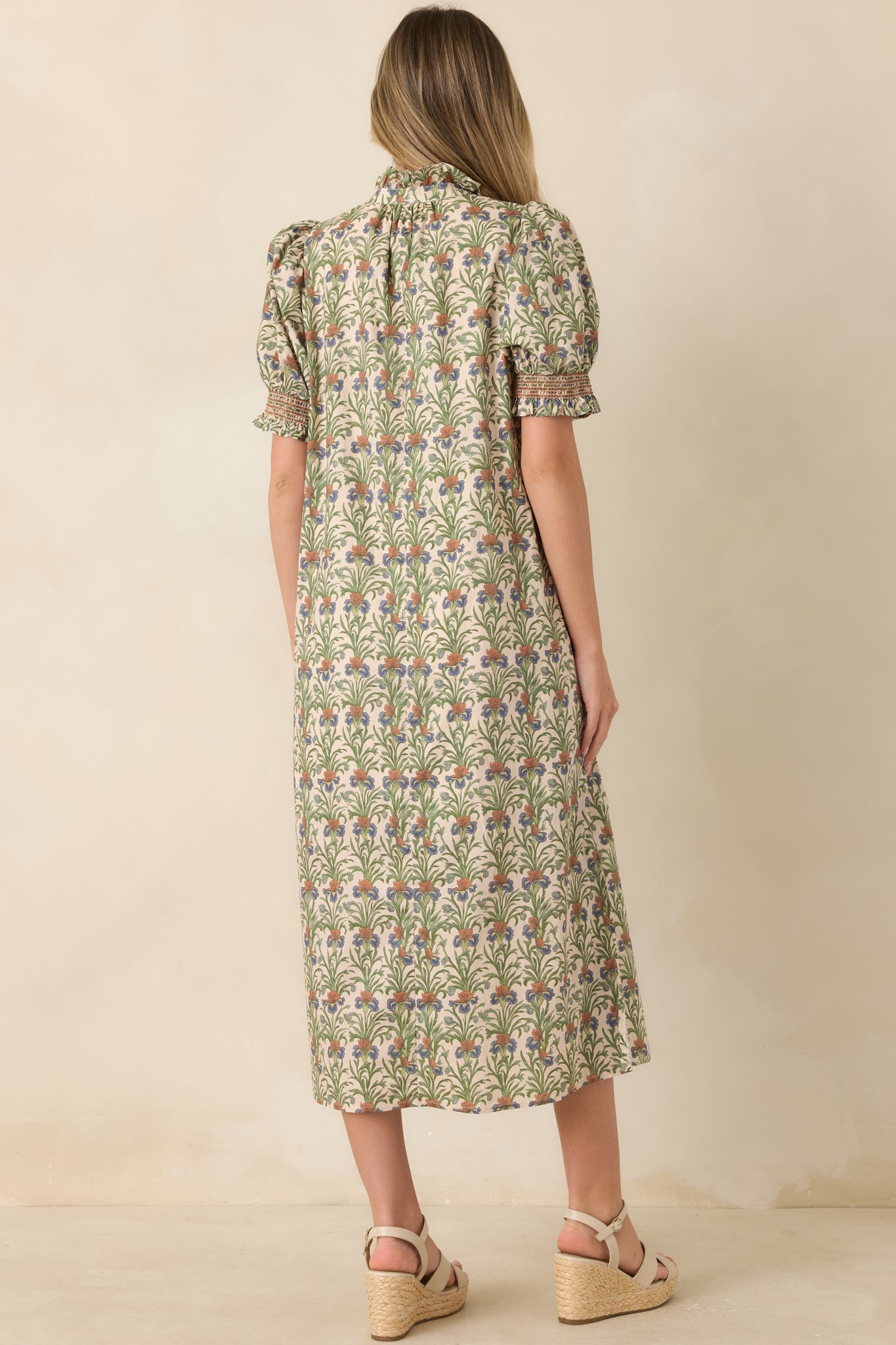 Rear view of the ivory botanical midi dress showcasing the relaxed A-line silhouette, puff sleeves, and flowing skirt.