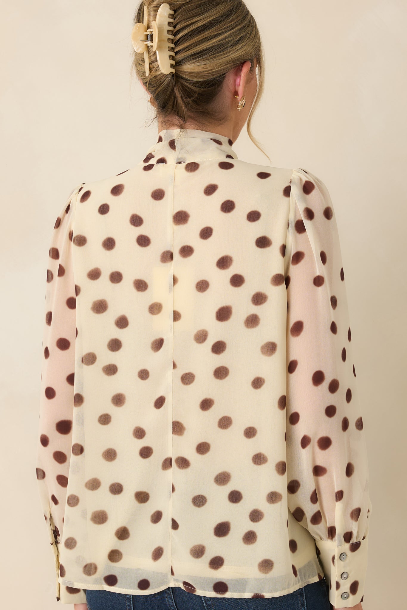Rear view of the ivory chiffon blouse showcasing the relaxed drape, gathered shoulders, and flowing back silhouette.