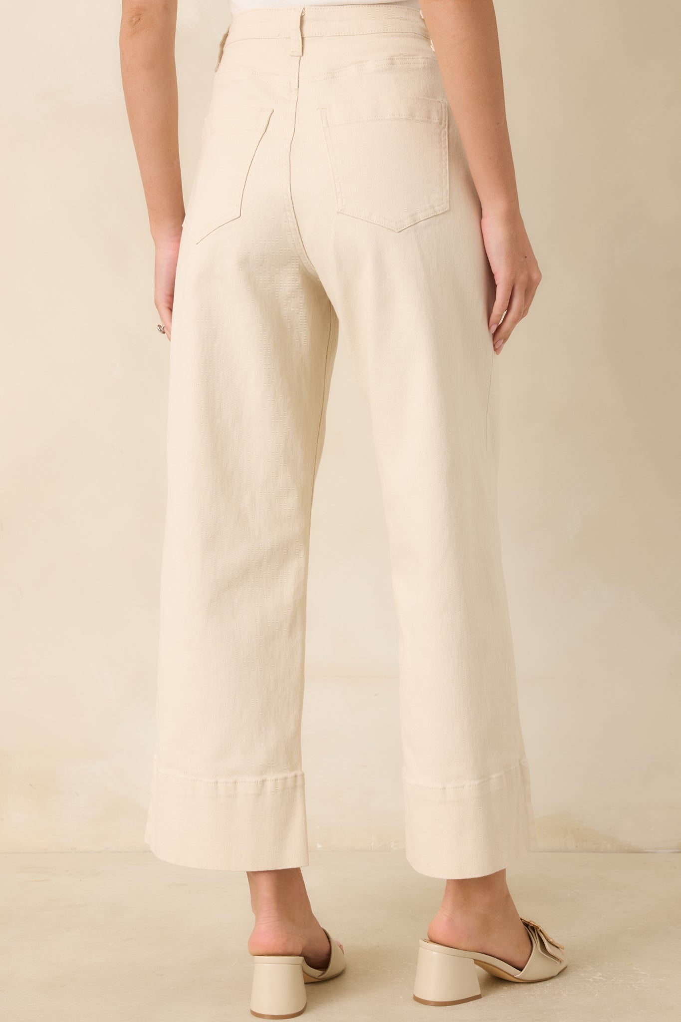 Rear view of the ivory cropped wide-leg pants featuring the clean back design and structured tailored silhouette.
