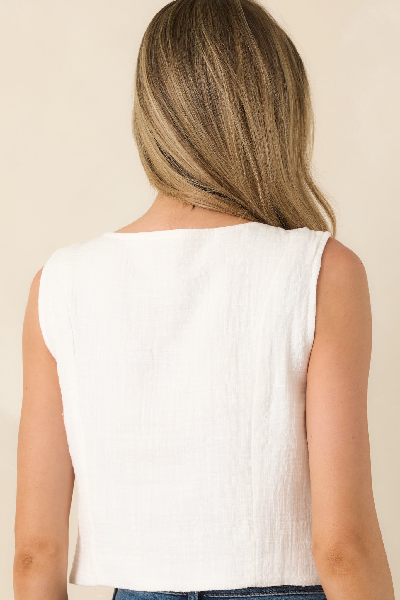 Rear view of ivory tank top with sleeveless cut and relaxed silhouette.