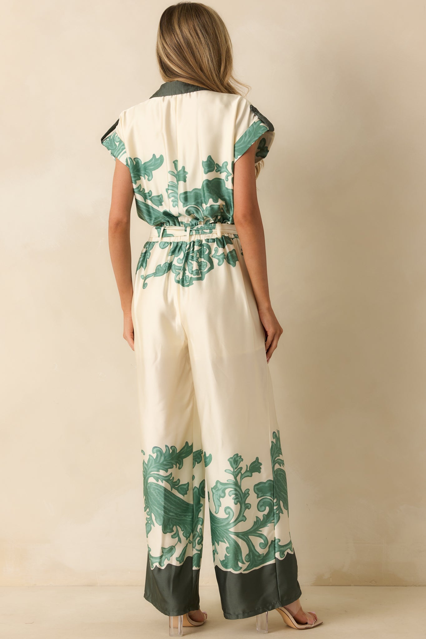 Rear view of jumpsuit featuring elastic back waistband insert, wide-leg silhouette, and flowing hem.