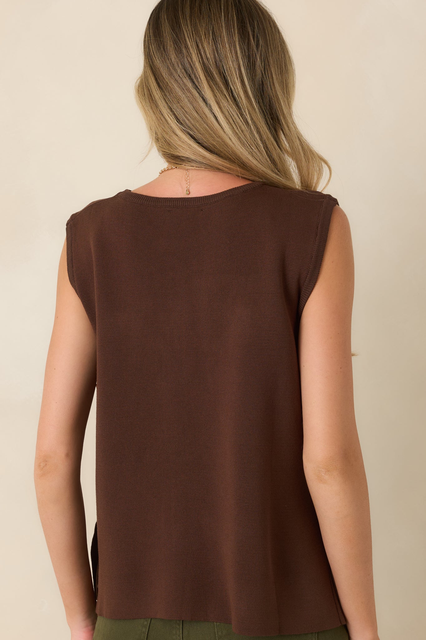 Rear view of the lightweight sweater knit top highlighting the smooth drape, relaxed sleeveless shape, and clean finish.