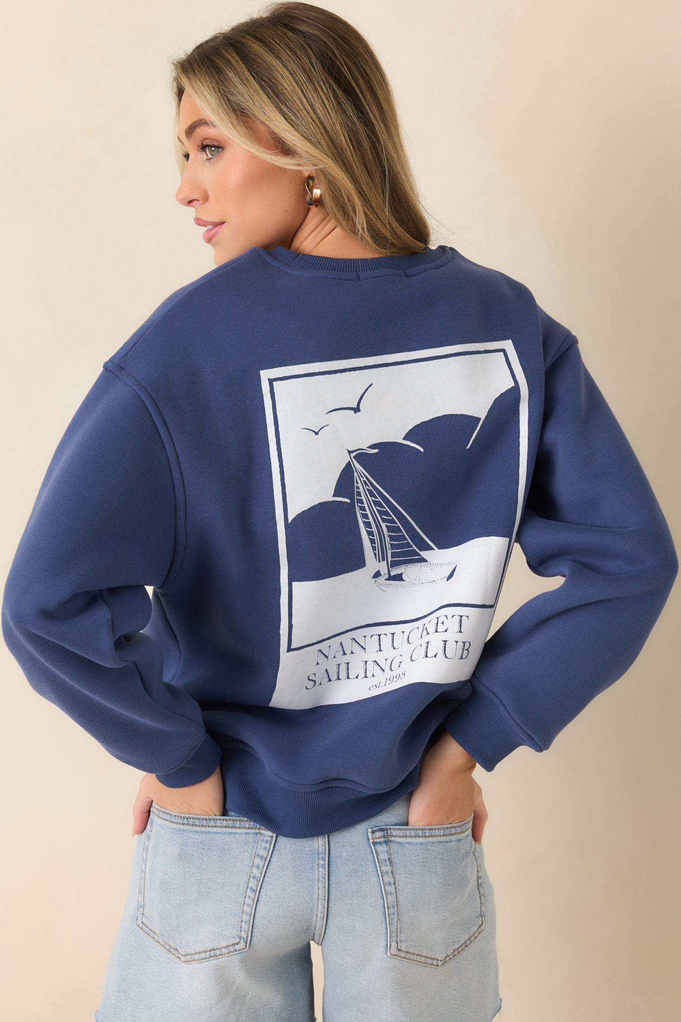 Rear view of navy crewneck sweatshirt featuring large Nantucket Sailing Club graphic.