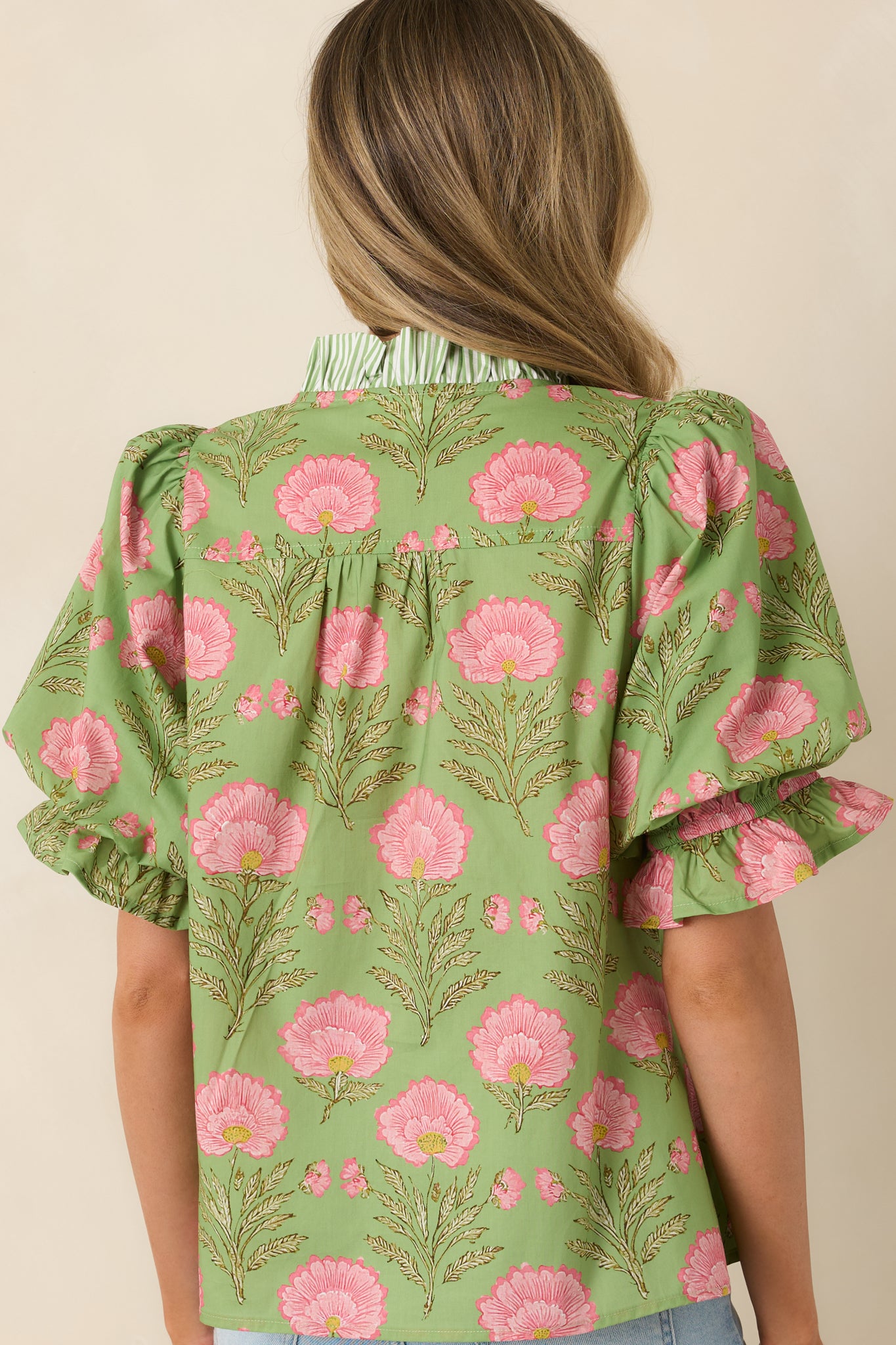 Rear view of puff sleeve cotton top with smooth, lightweight finish.