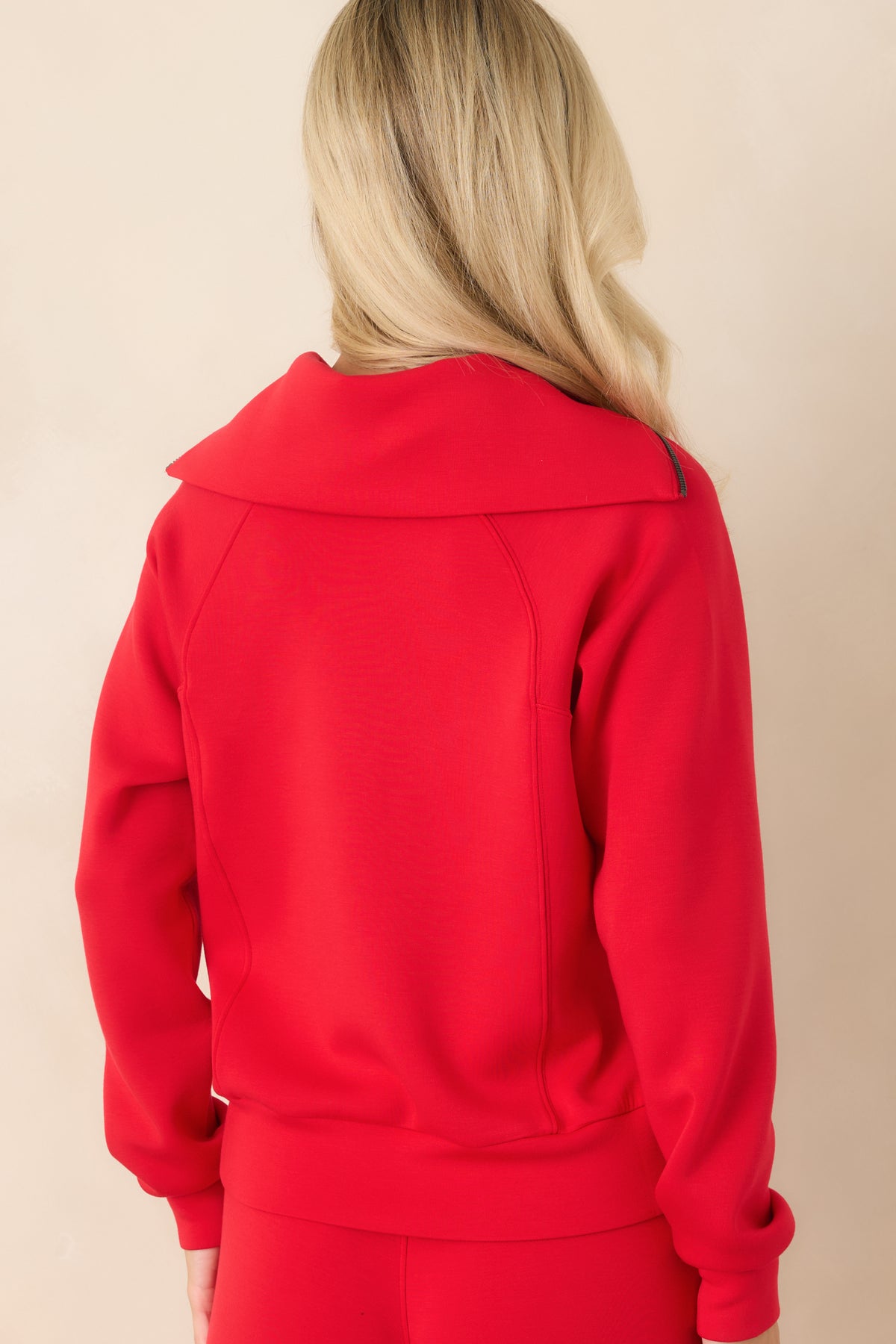 Rear view of the pullover showcasing the relaxed silhouette, long sleeves, and wide banded hem
