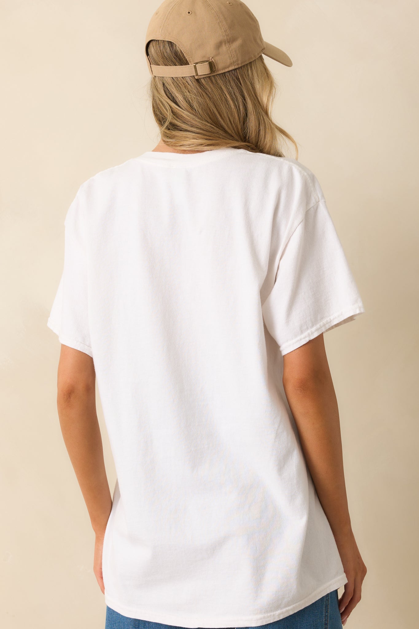 Rear view of white oversized tee showing smooth cotton fabric and relaxed fit.