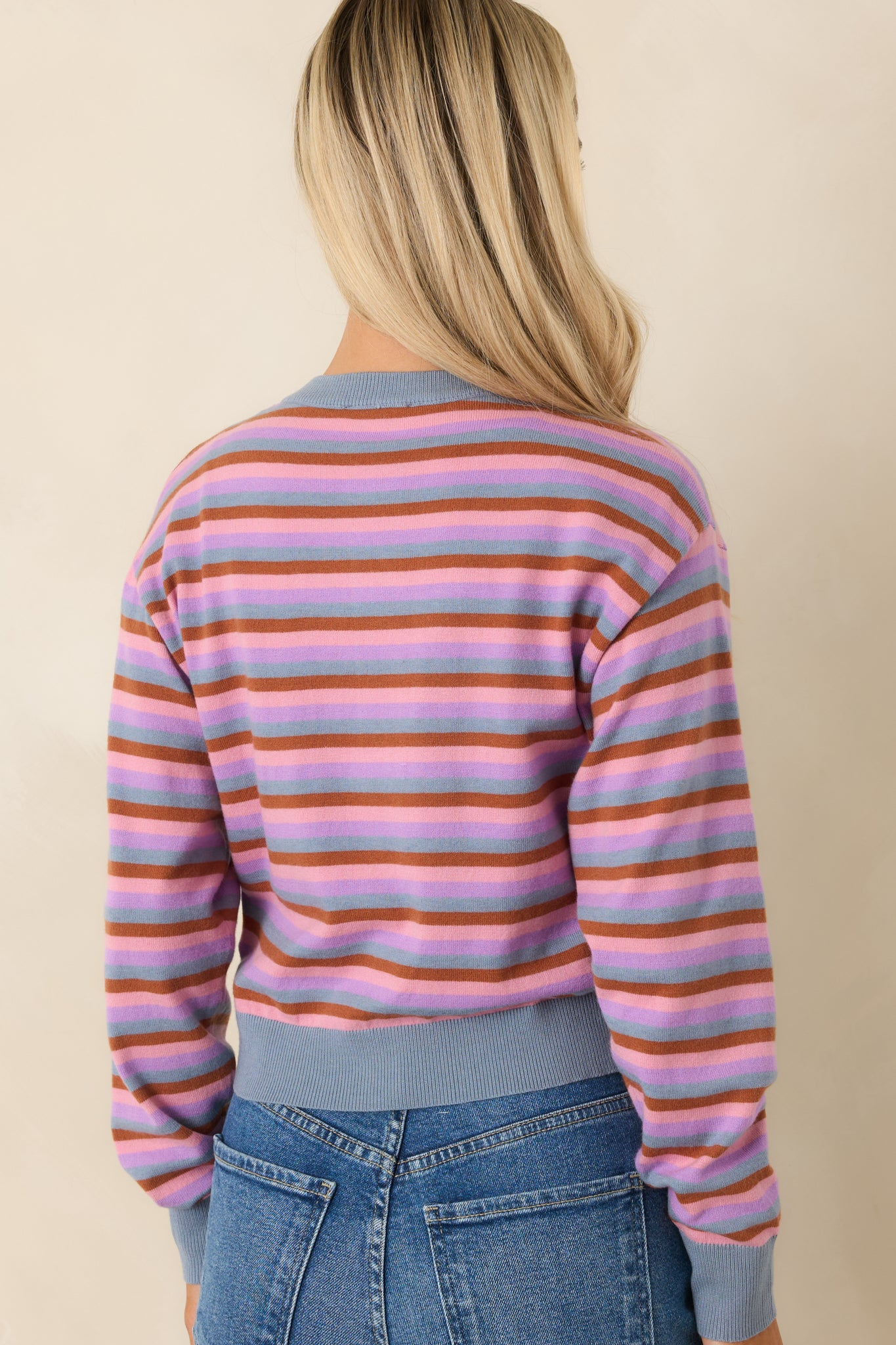 Rear view of striped knit cardigan with soft texture and relaxed shape.
