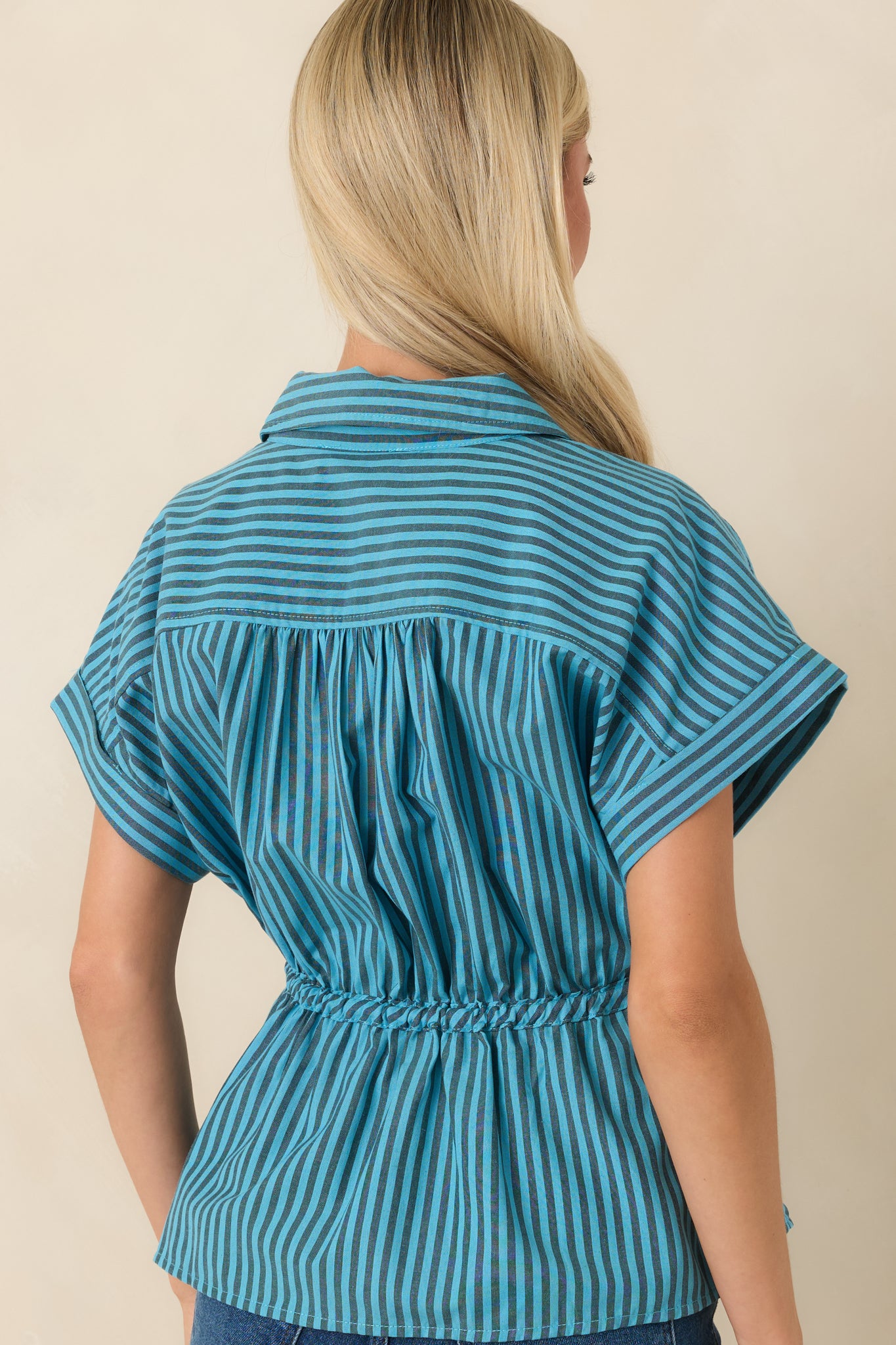 Rear view of the striped top showcasing the gathered back yoke and relaxed shape.