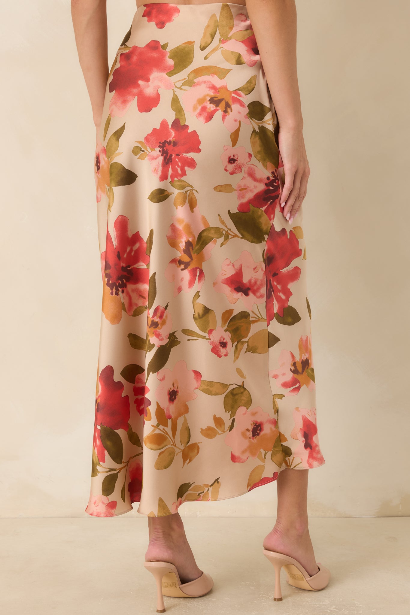Rear view of the tan maxi skirt highlighting the smooth waistband, flowing silhouette, and allover floral print.