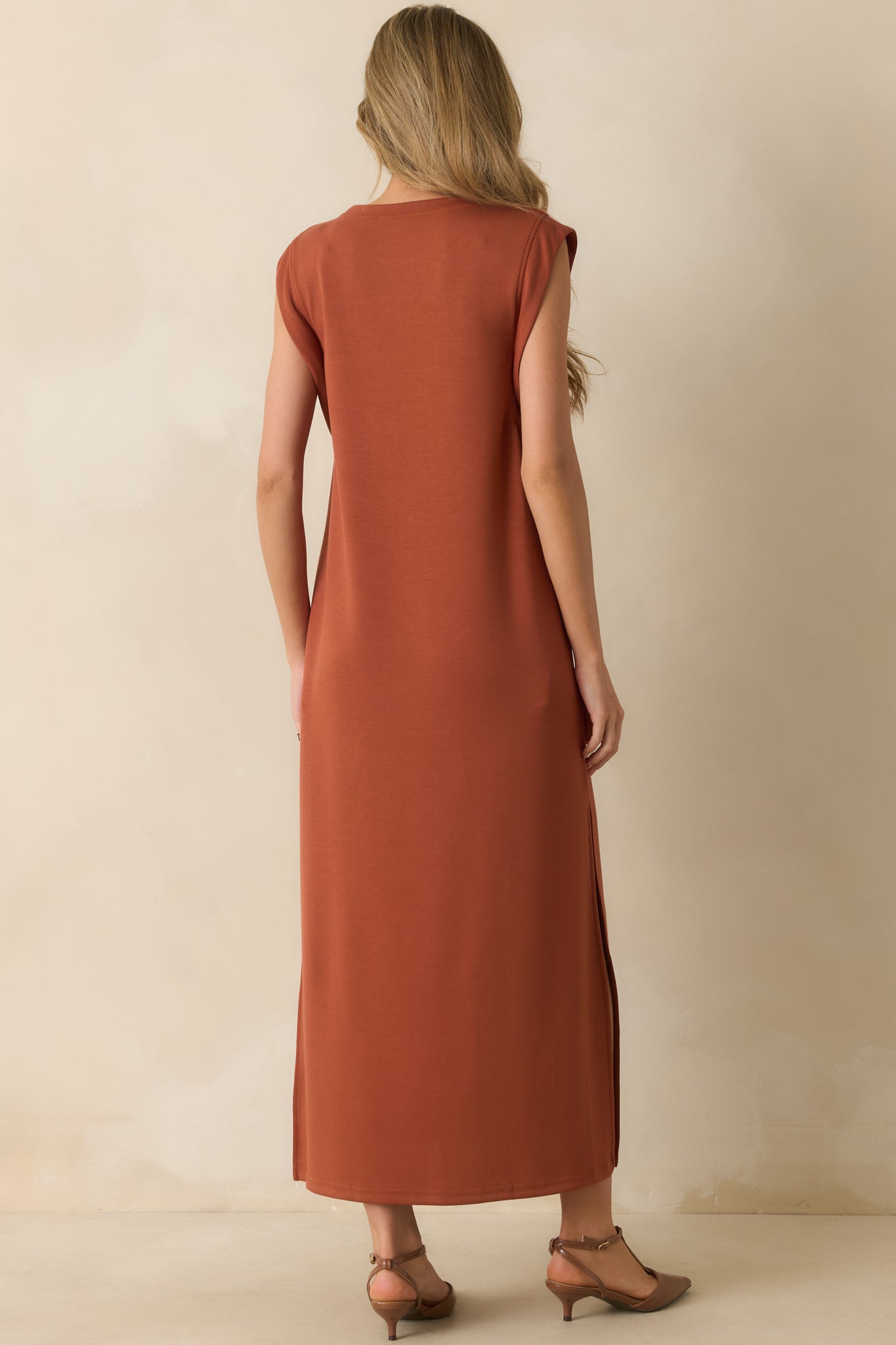 Rear view of the terracotta maxi dress with cap sleeves, relaxed fit, and straight hemline.