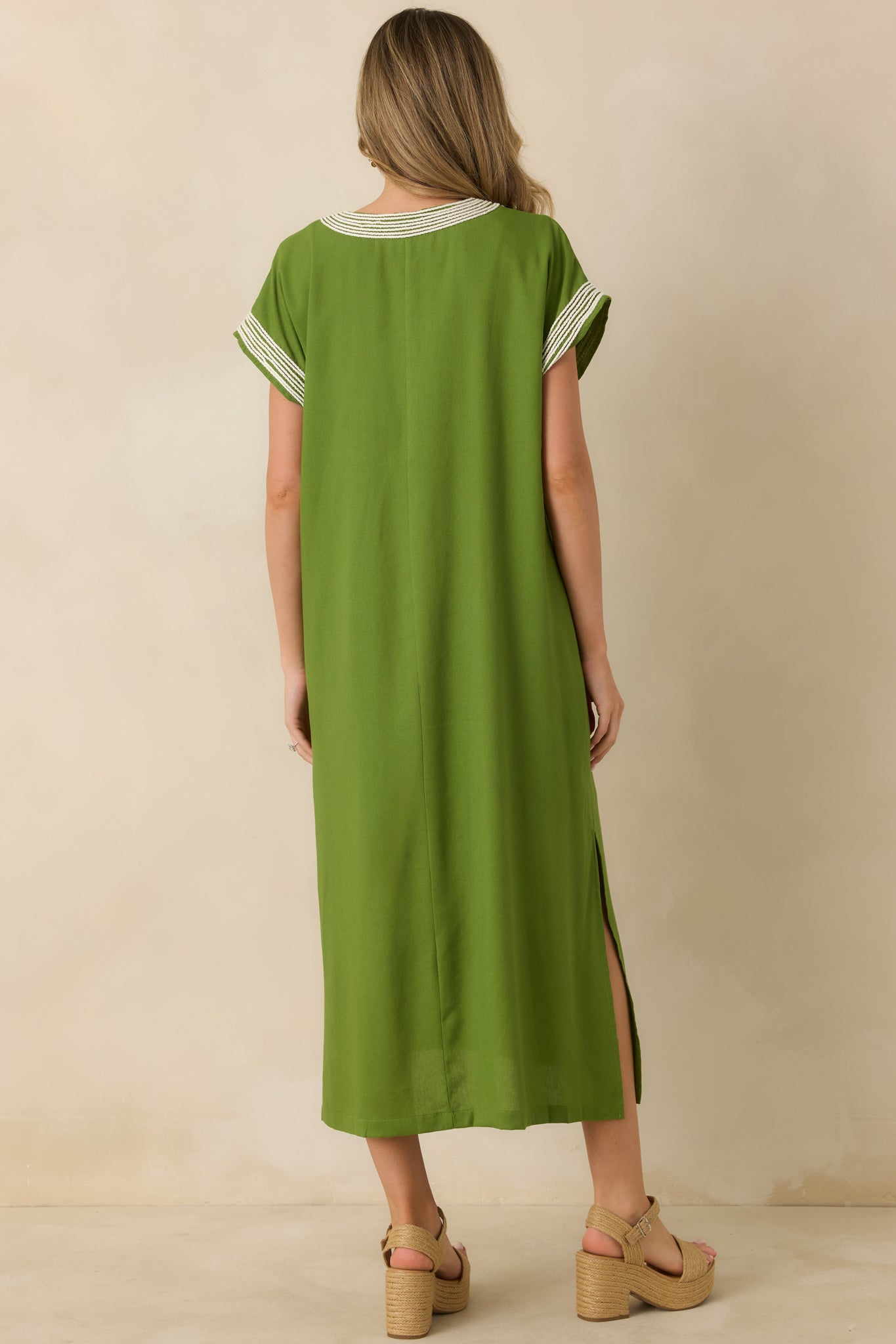 Rear view of the green maxi dress highlighting the straight silhouette, lightweight fabric, and cap sleeves.