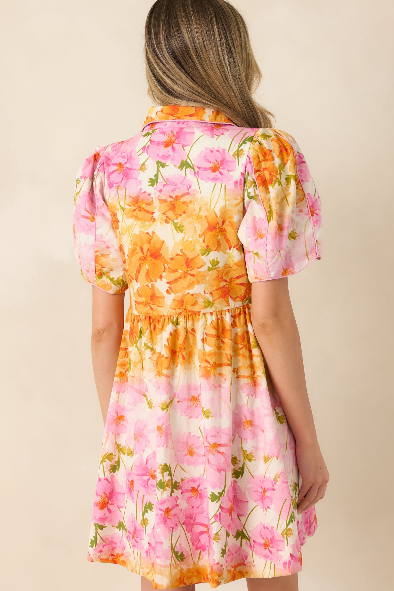 Rear view of the mini dress featuring a gently gathered waist and smooth, structured silhouette.
