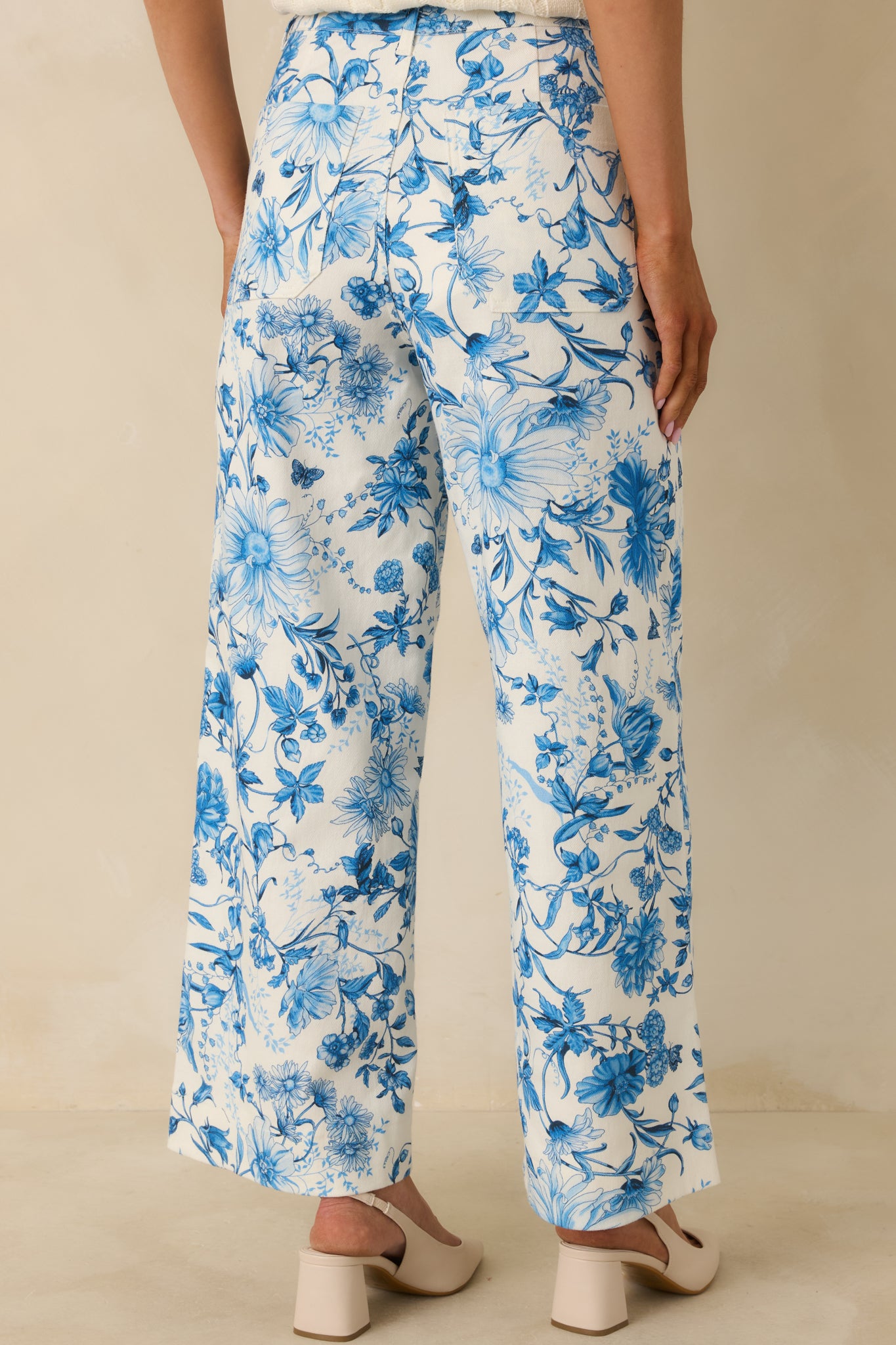 Rear view of the blue floral cotton pants showing patch pockets, high-rise fit, and wide-leg silhouette.