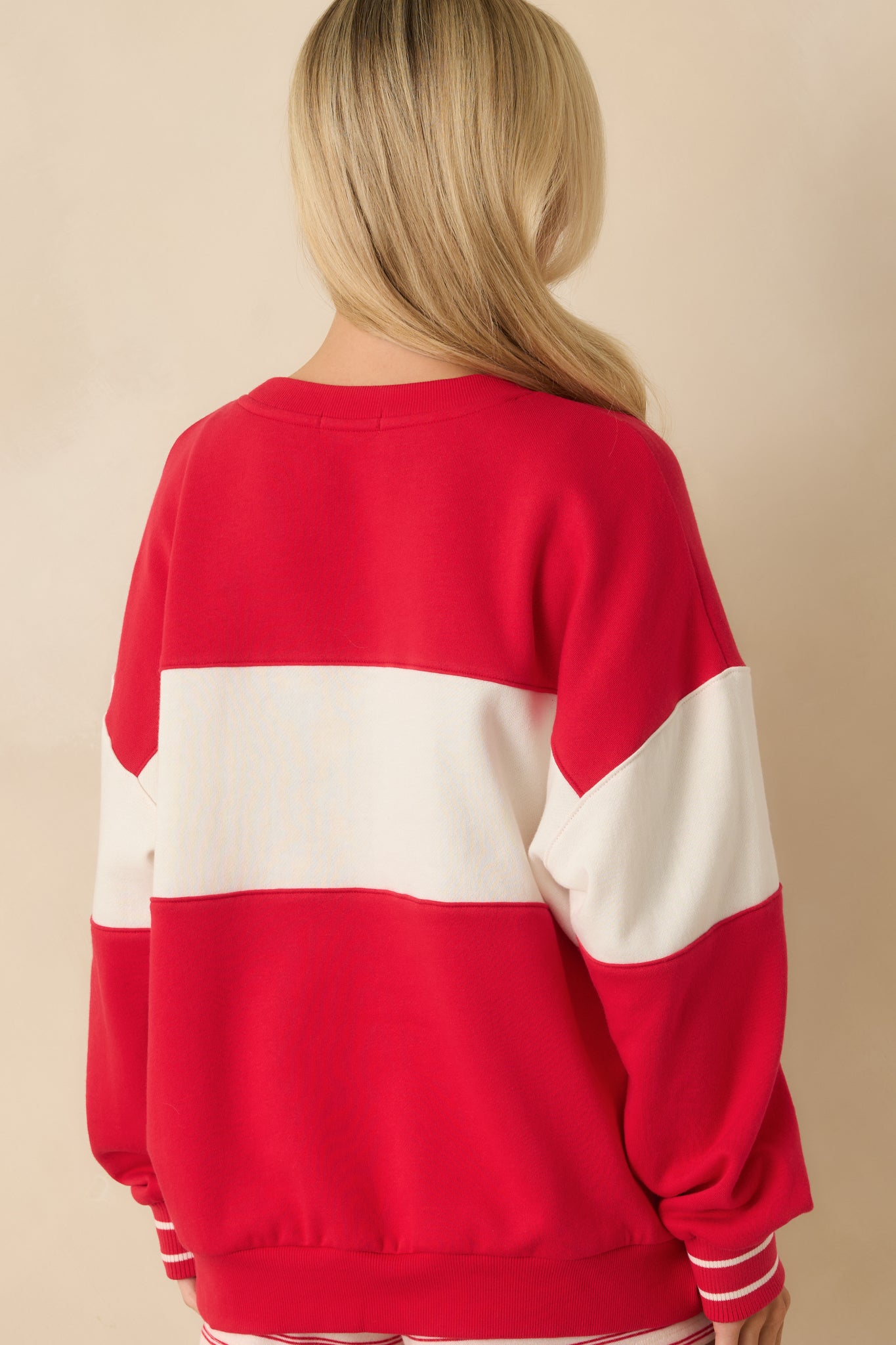 Rear view of the red sweatshirt displaying the oversized fit and smooth fleece finish