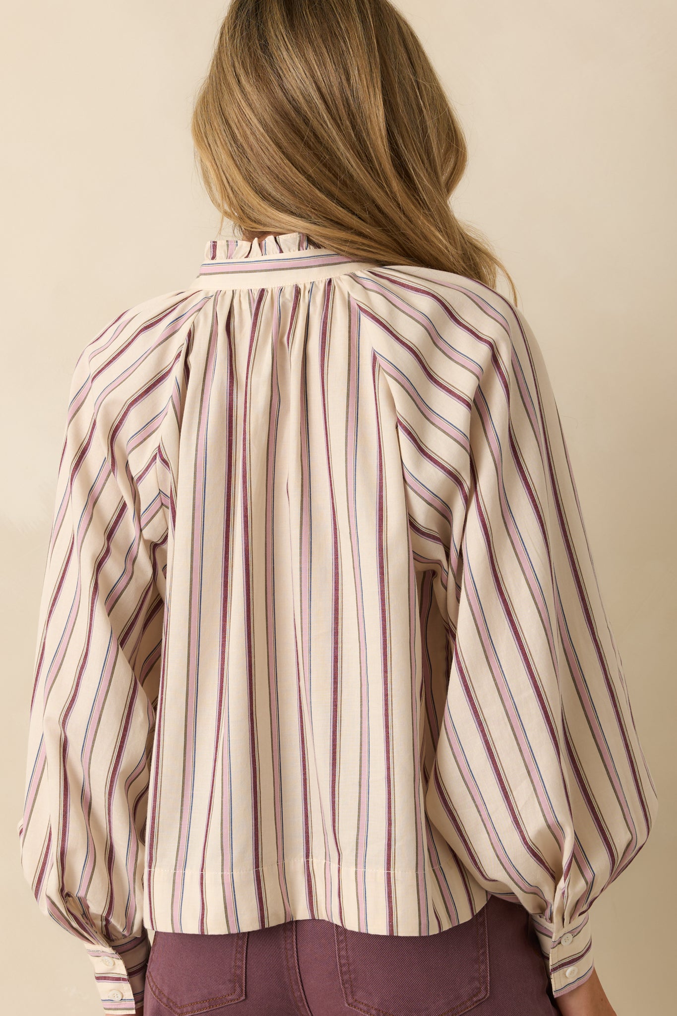 Rear view of the striped shirt showing the relaxed fit, long sleeves, and continuous stripe pattern.
