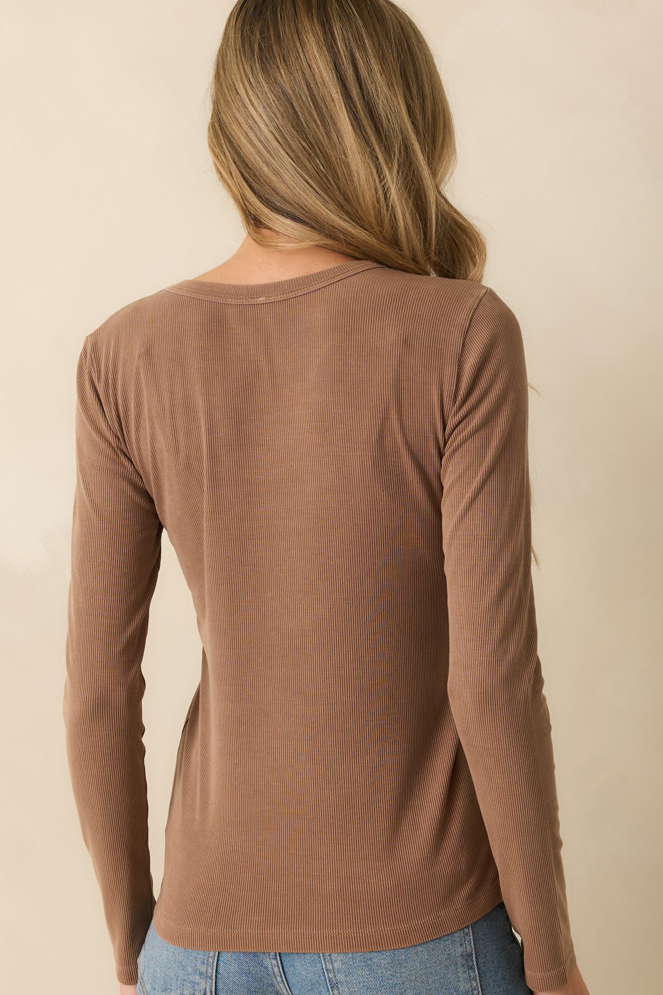 Rear view of the mocha brown top highlighting the relaxed fit and long sleeves.