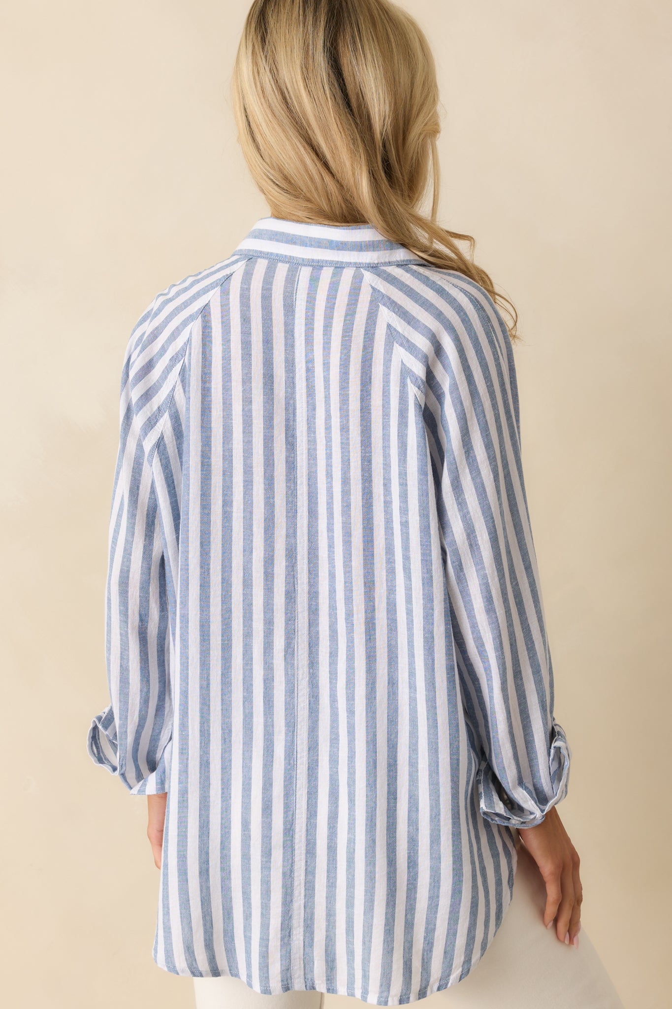 Rear view of the top, showing the full stripe pattern and long sleeve design.