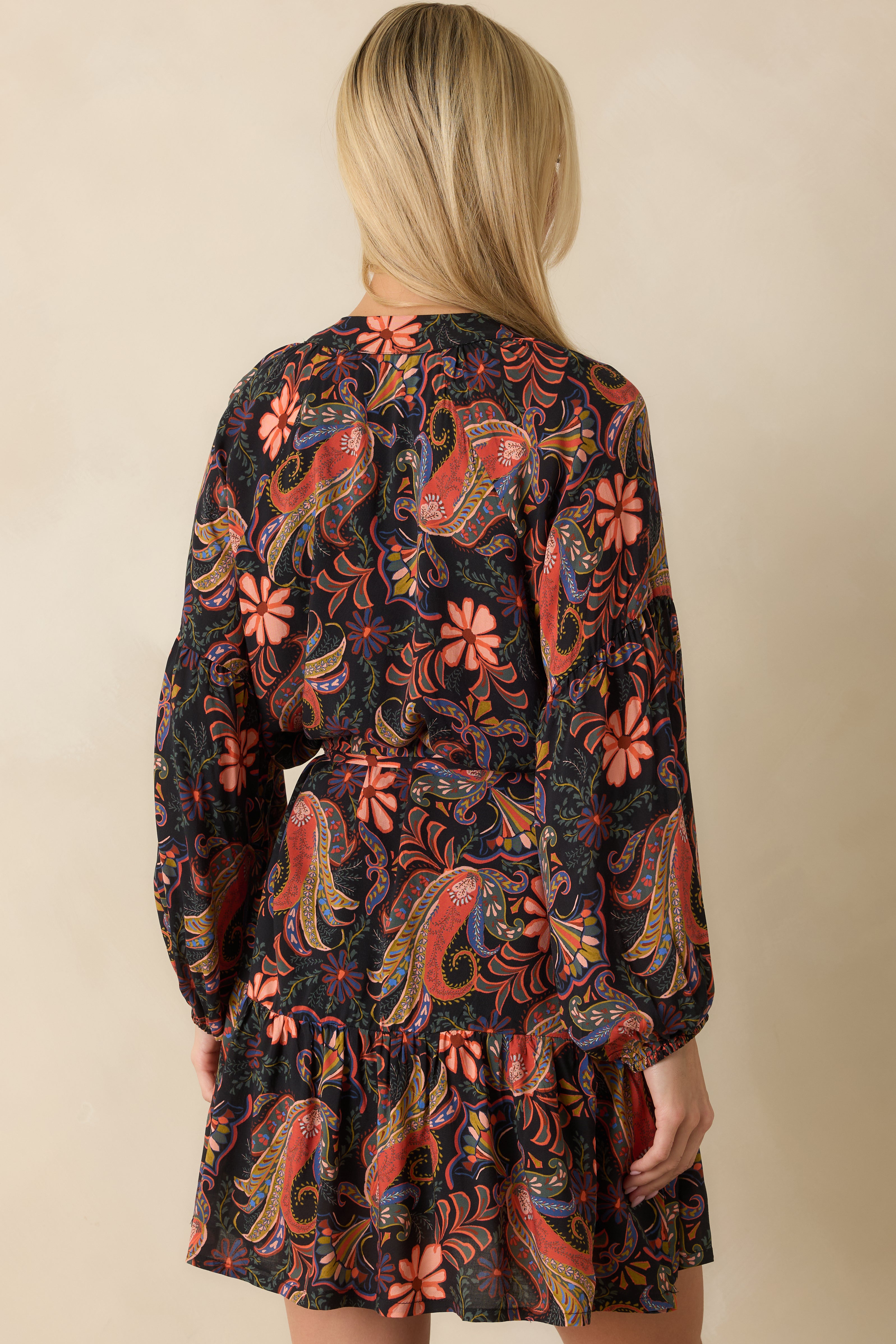 Rear view of the orange floral paisley mini dress showing tiered skirt and relaxed fit