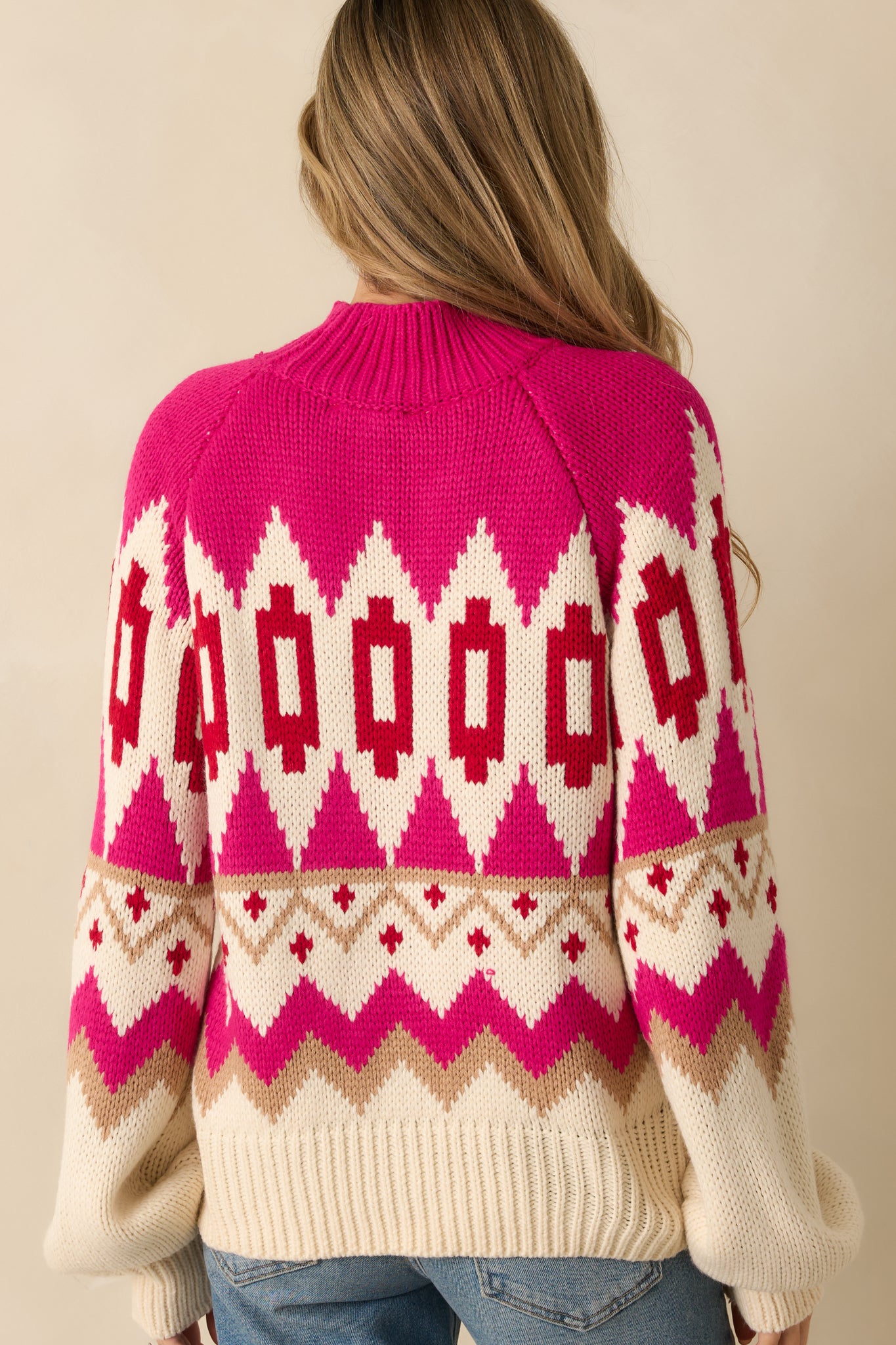 Rear view of the pink multi Fair Isle sweater showing the relaxed fit and ribbed hemline.