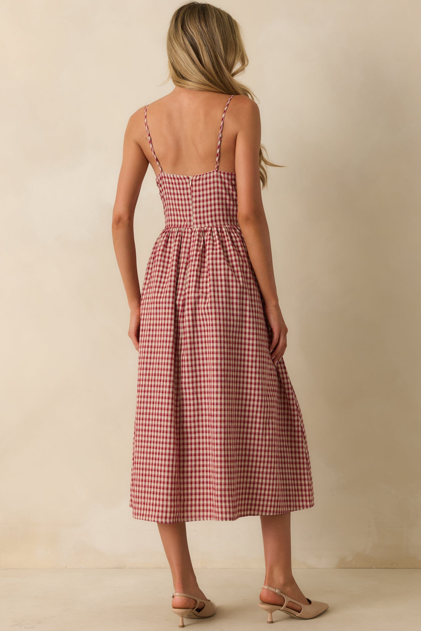 Rear view of the red gingham midi dress highlighting smocked back panel and hidden zipper closure.