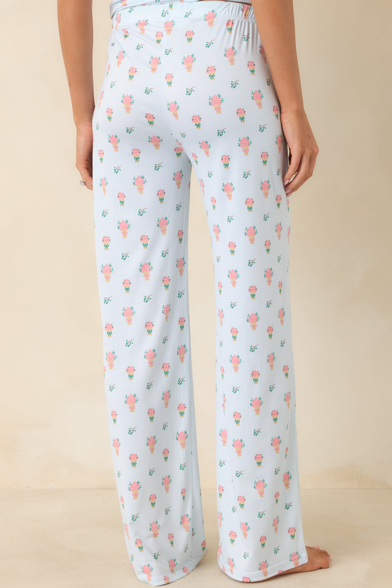 Rear view of the light green floral lounge pants showcasing the relaxed silhouette and comfortable elastic waistband.