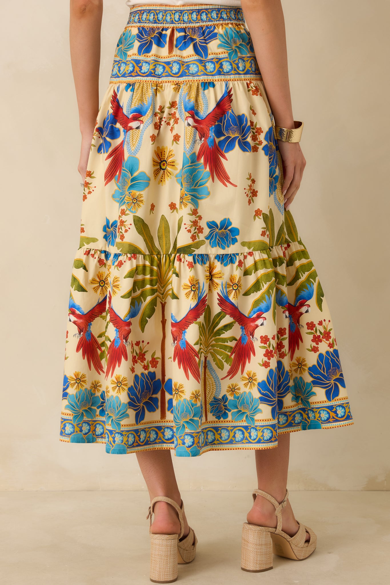 Rear view of multicolored maxi skirt showing smooth high-rise waistband, tiered silhouette, and flowing fabric.