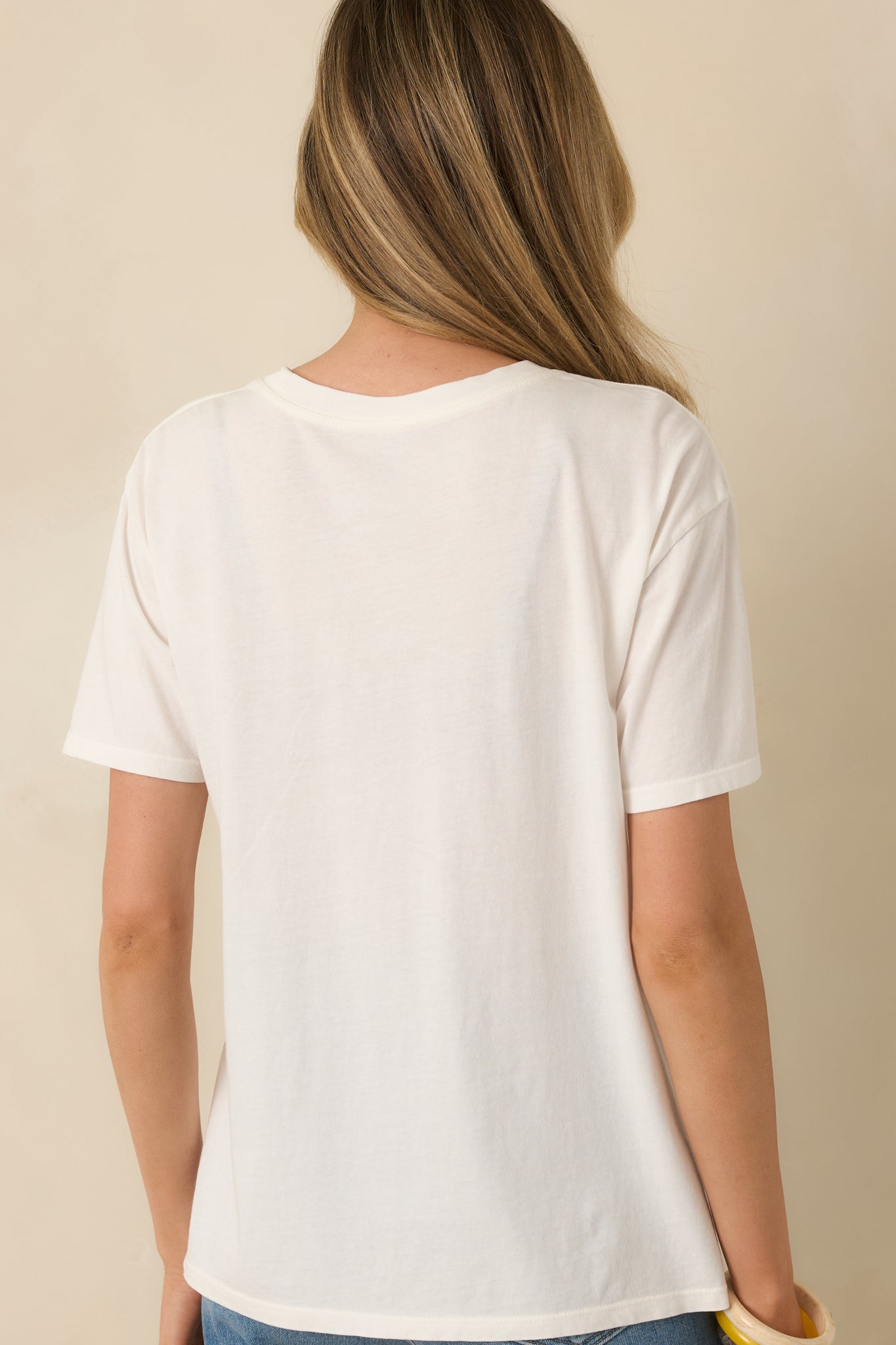 Rear view of the white cotton jersey tee showing the clean design, short sleeves, and relaxed boyfriend fit.