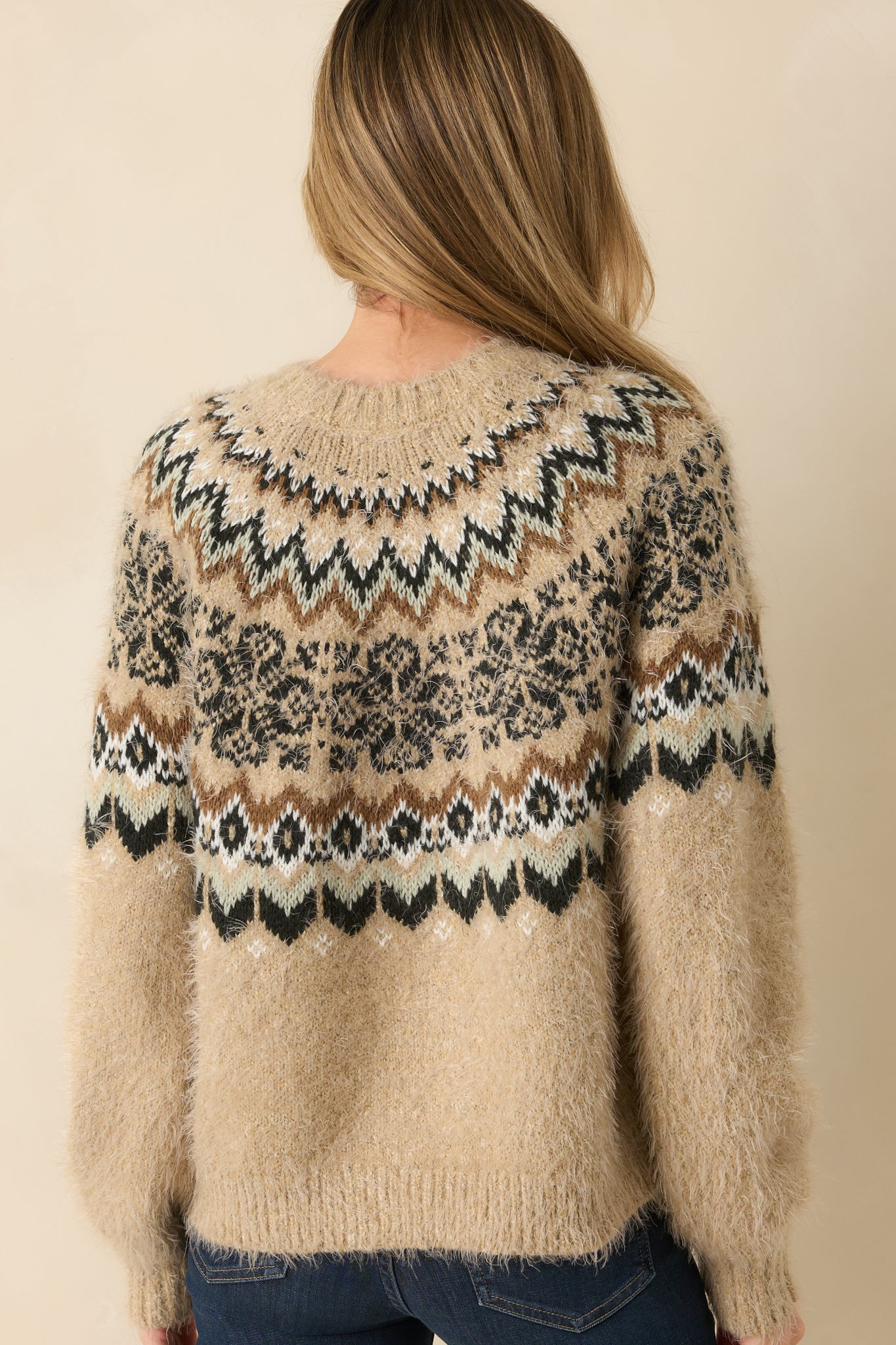 Rear view of the oatmeal heather sweater showing the relaxed shape and pattern continuation.